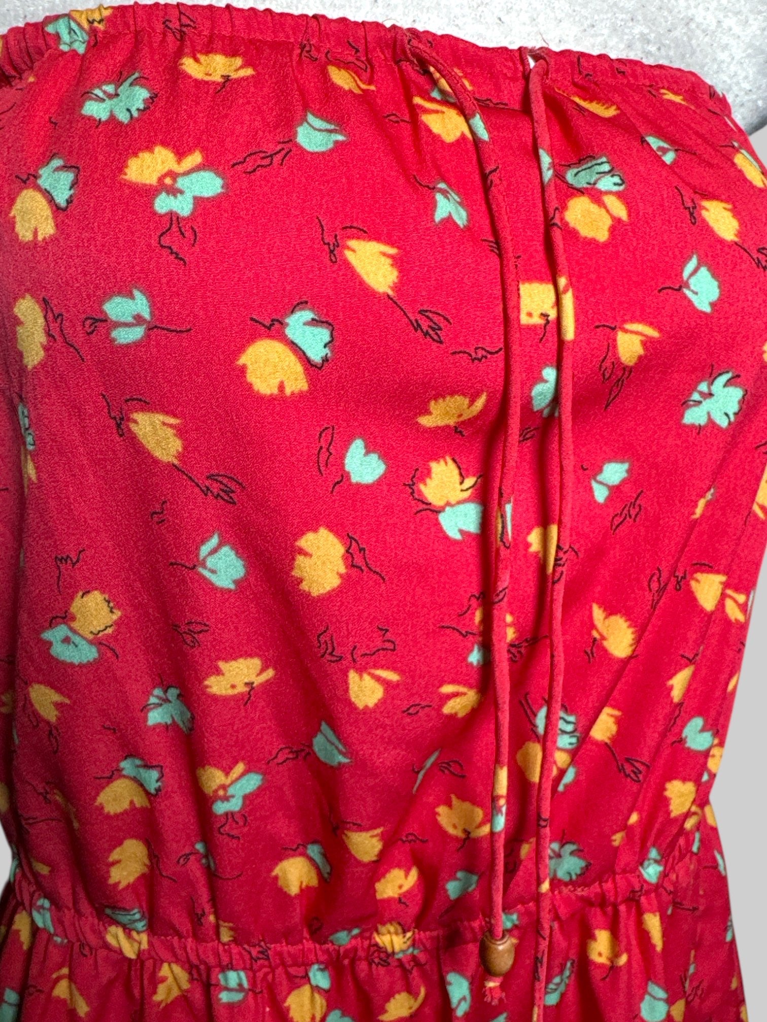 L O’ NEILL red strapless dress with drawstring and yellow, green, and black florals