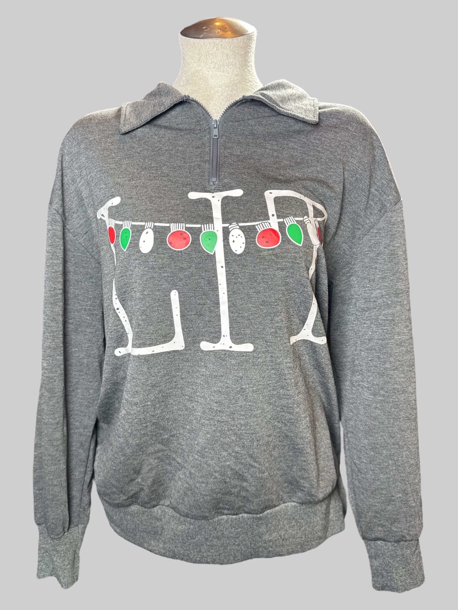 M Heathered gray pullover sweater with white “Lit” and Christmas lights