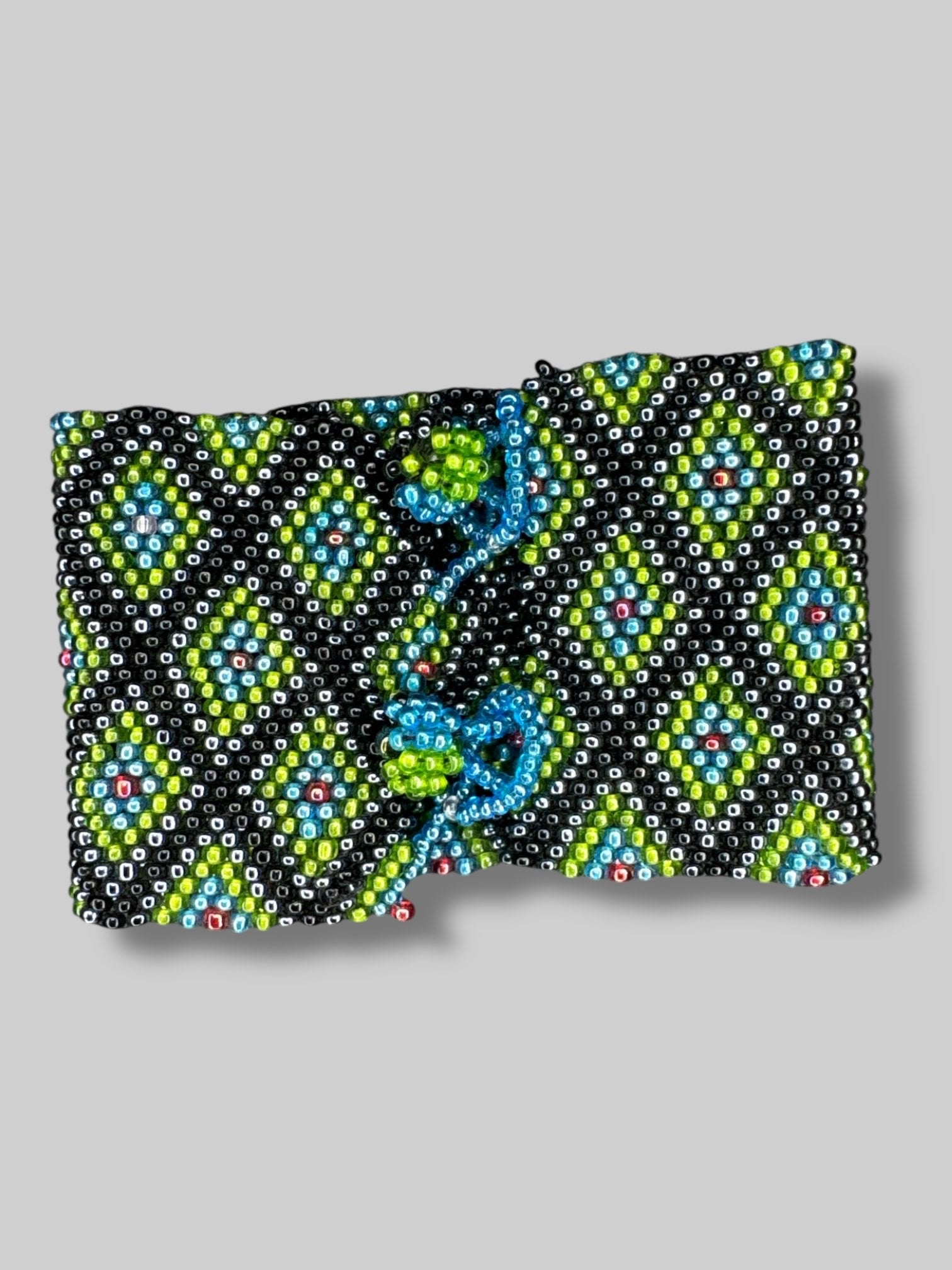 7” long unclasped beautiful green, blue, black, and red beaded bracelet