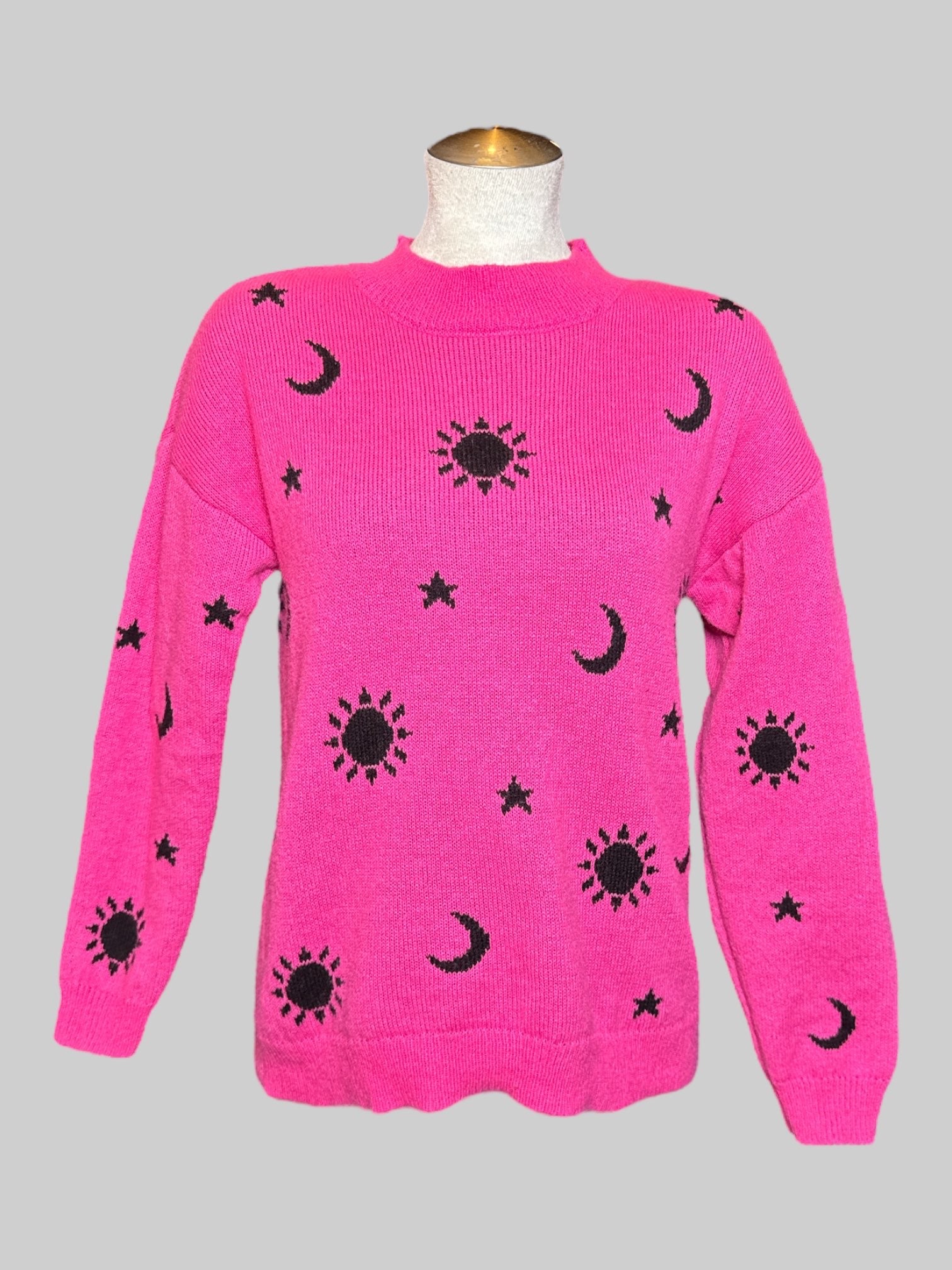 M No Boundaries pink knit long sleeve sweater with black moons, stars, and suns