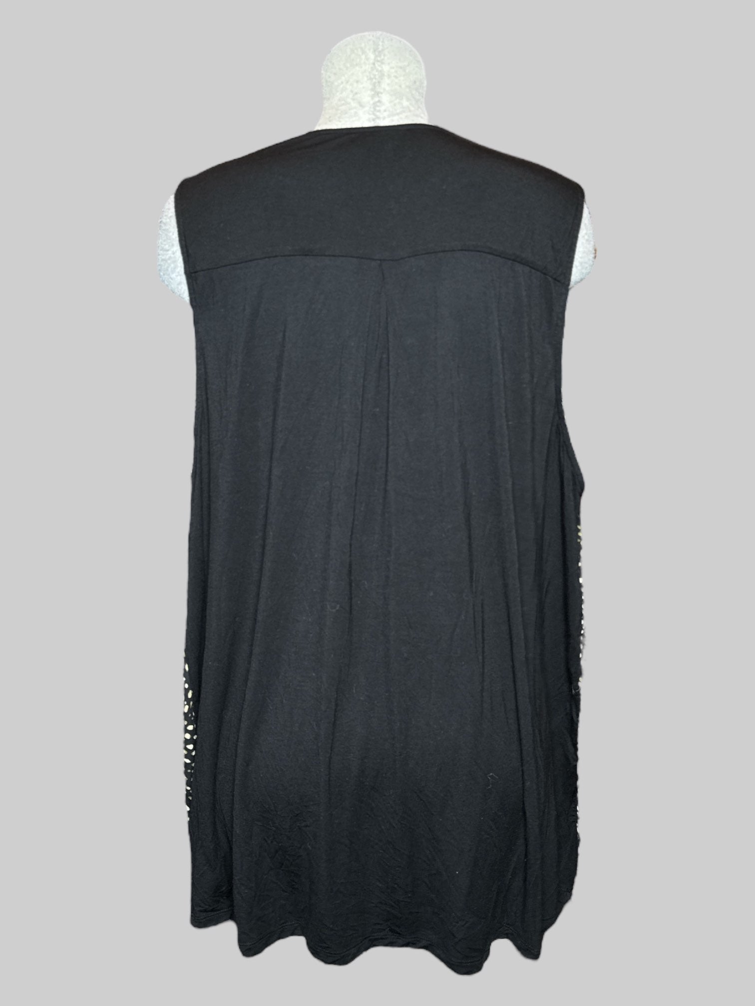 3X Torrid black sleeveless top with faux buttons, green, white, and tan spotted front panel, and black pleated back panel