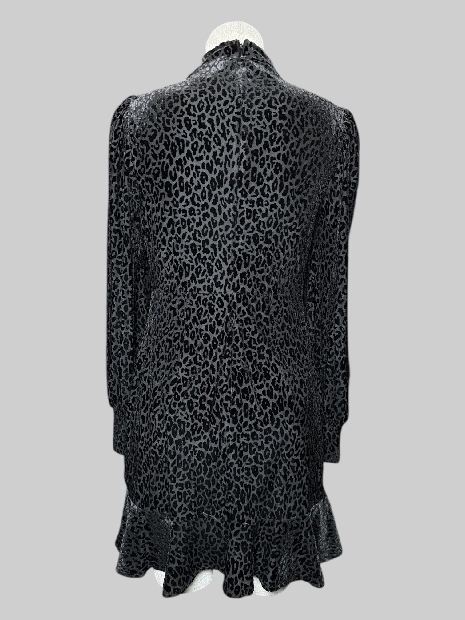 S Express black long sleeve dress with black velvet burn out leopard print, pleated right shoulder, and ruffle hem