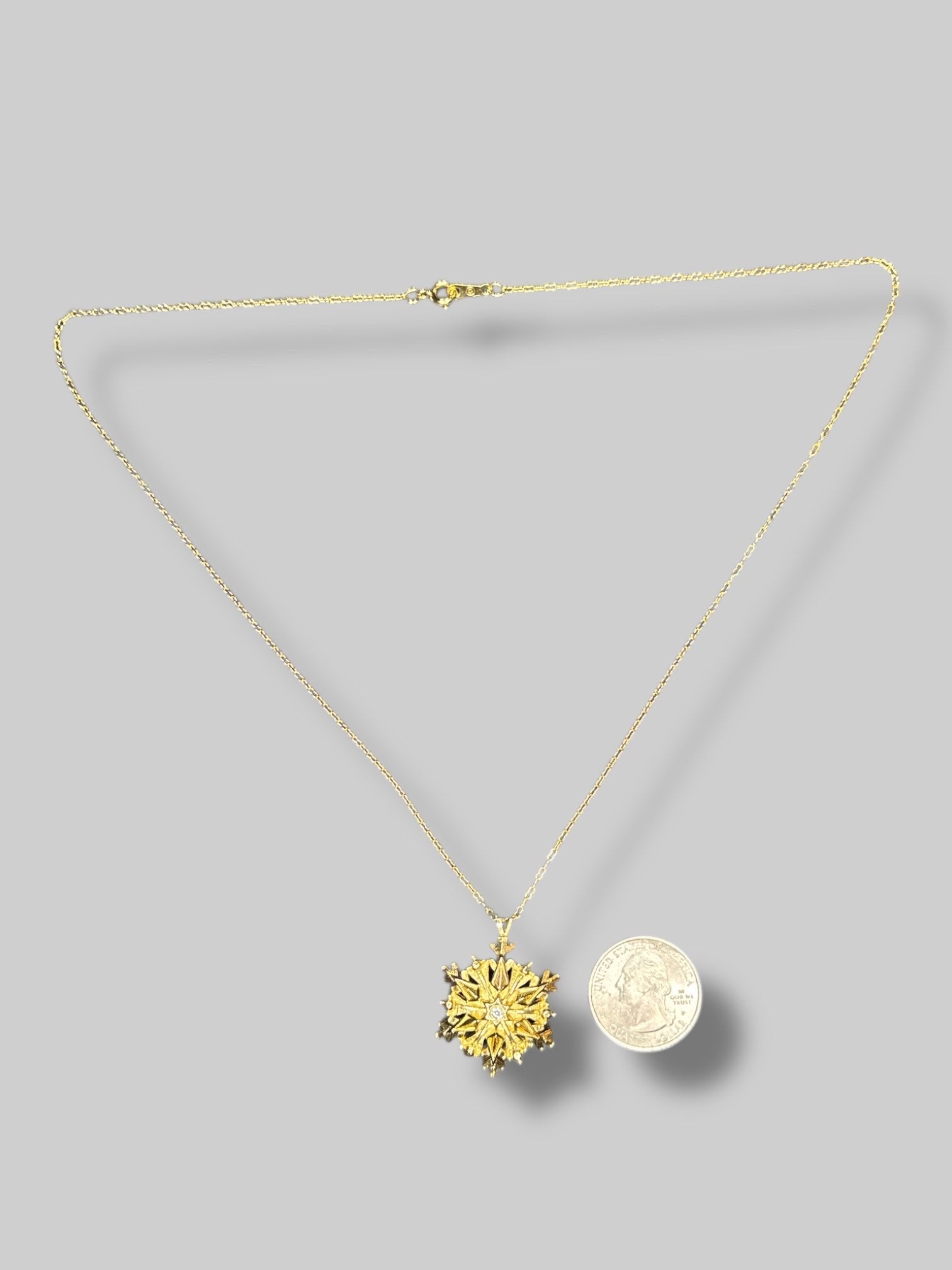 Gold tone snowflake necklace