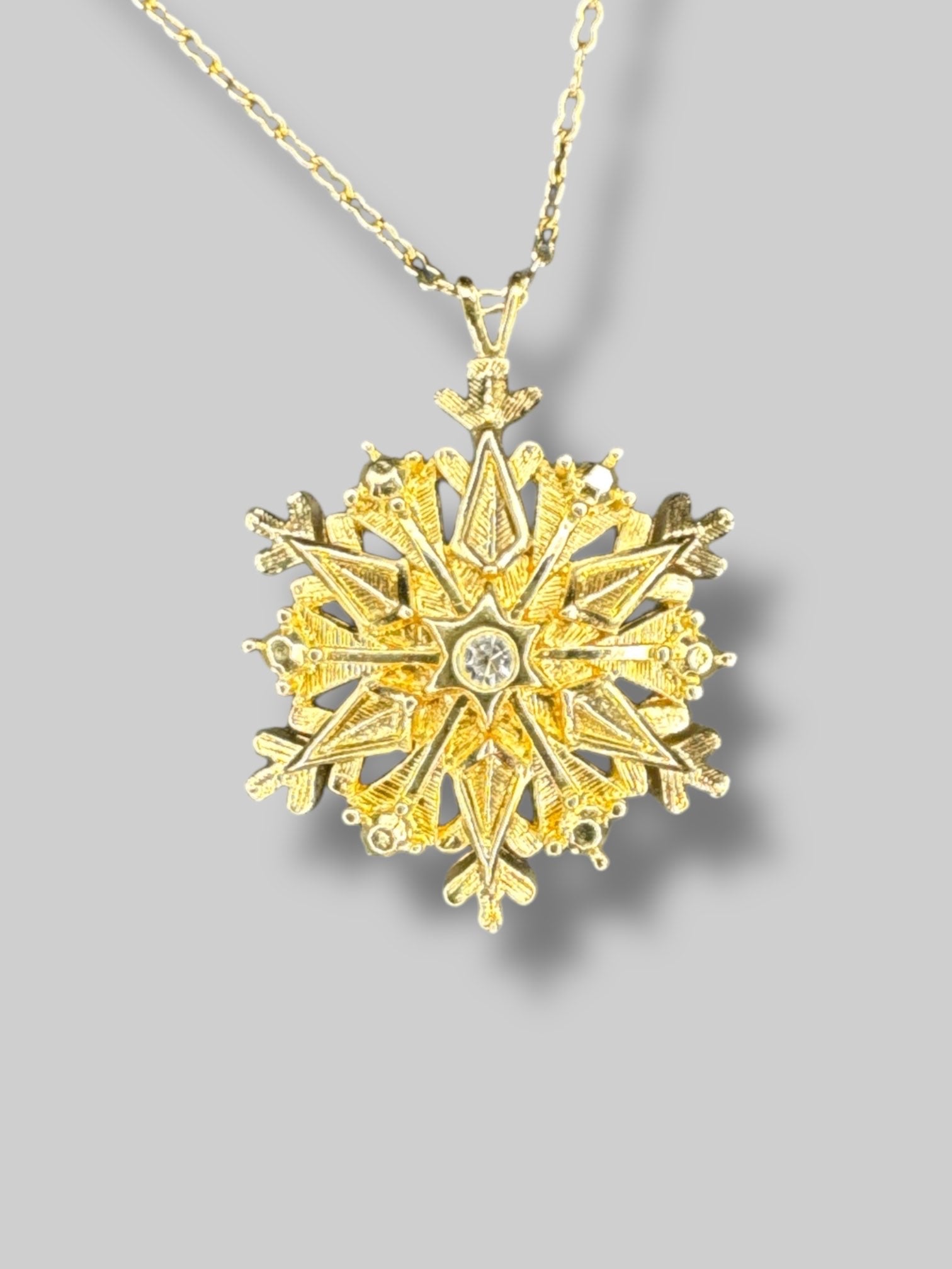Gold tone snowflake necklace
