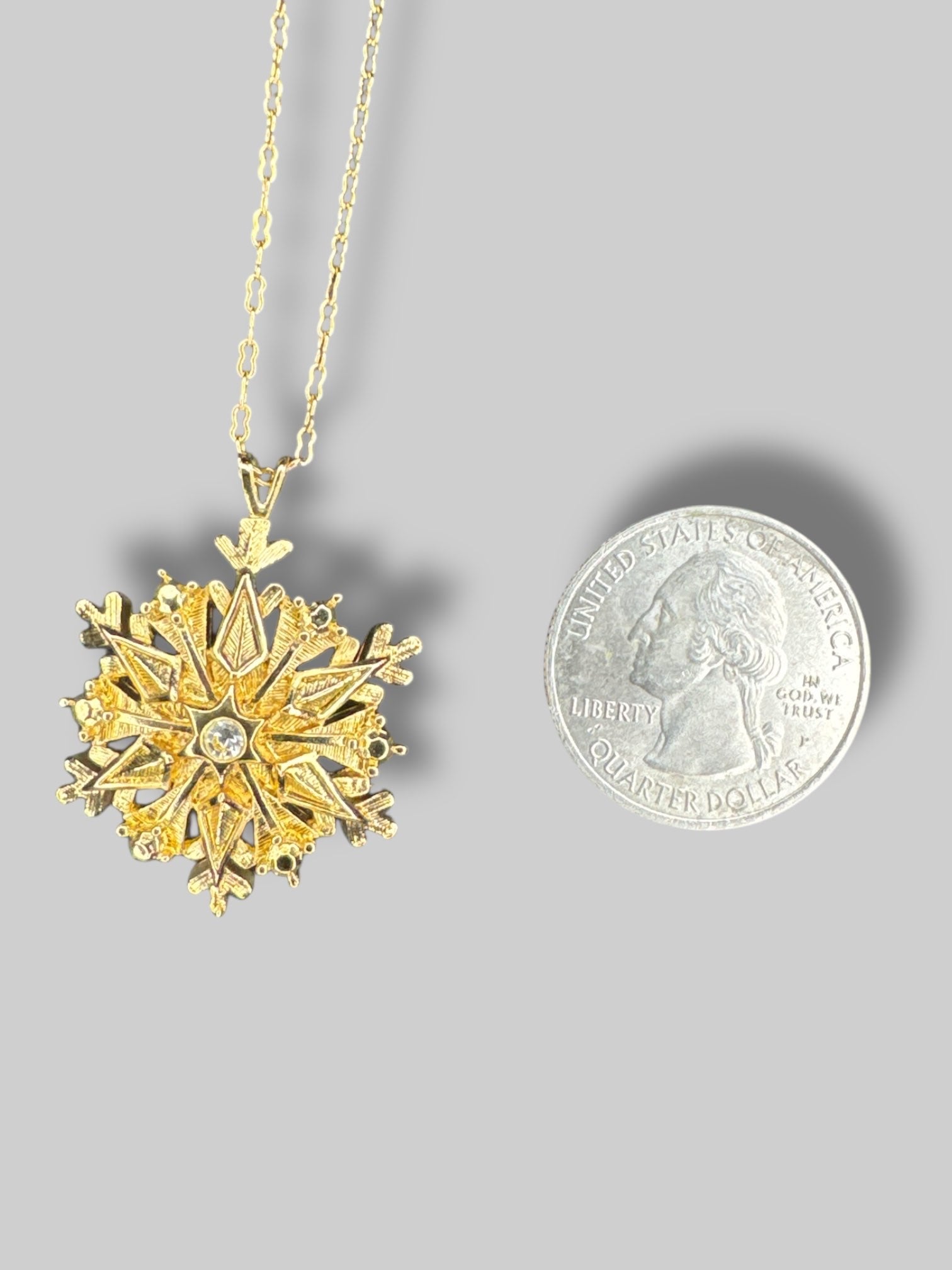 Gold tone snowflake necklace