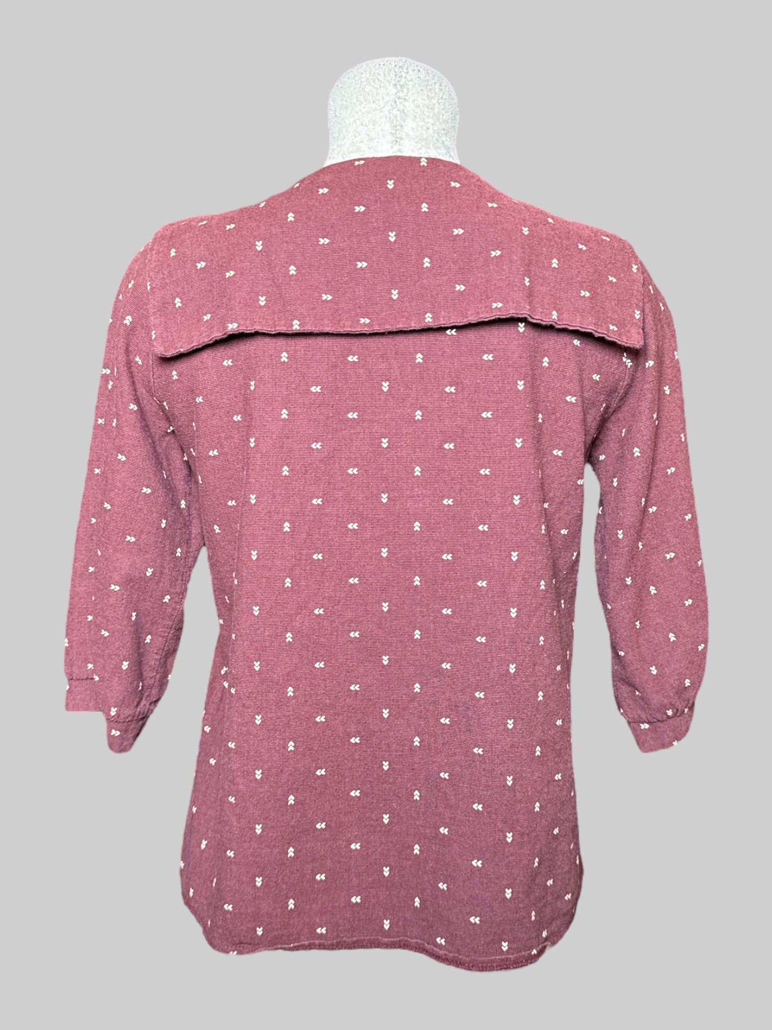 M Rich N. maroon half sleeve top with big collar, tie on front, and off white directional arrow design