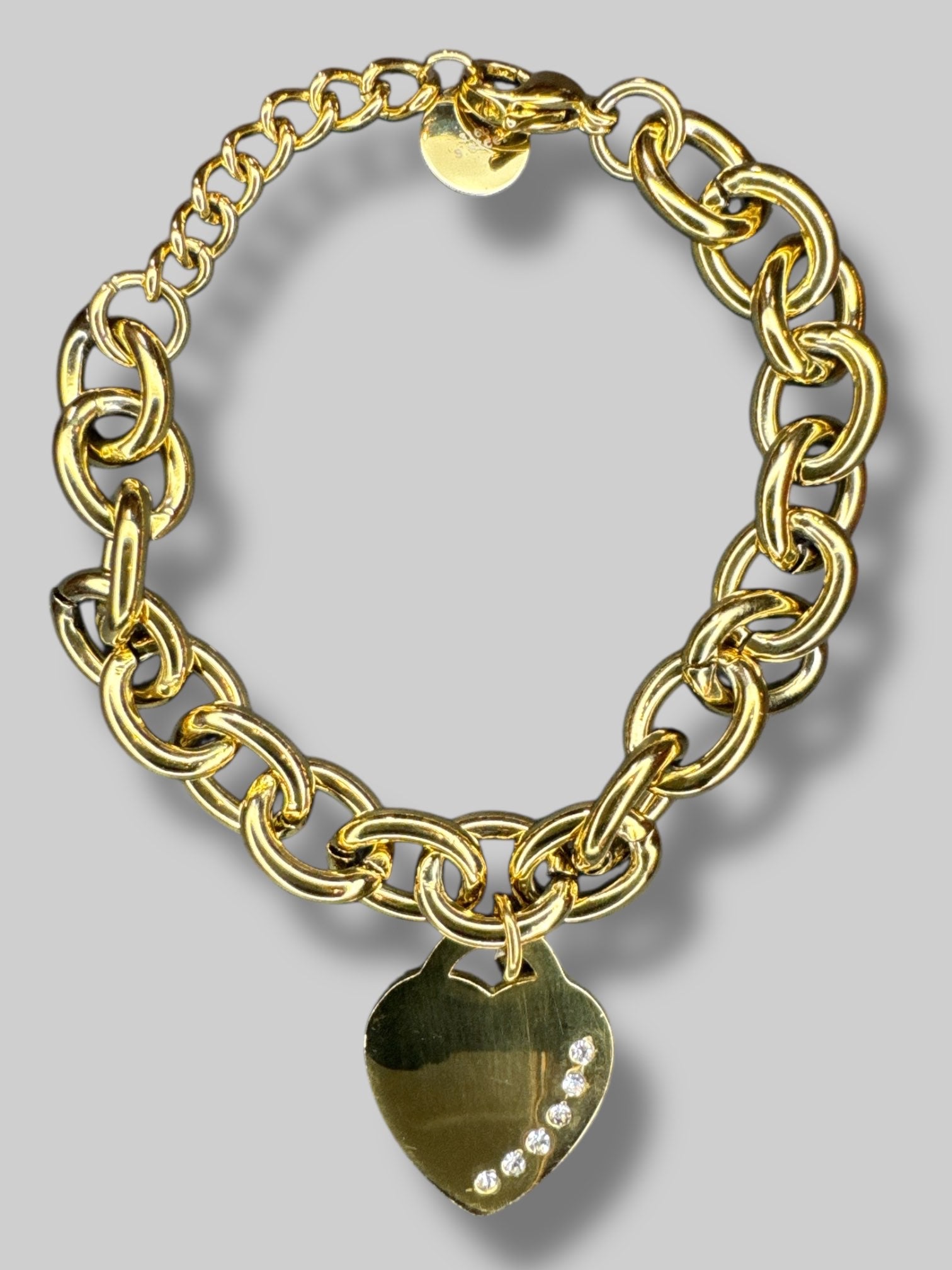 Gold metal chain bracelet with heart pendant with bedazzling