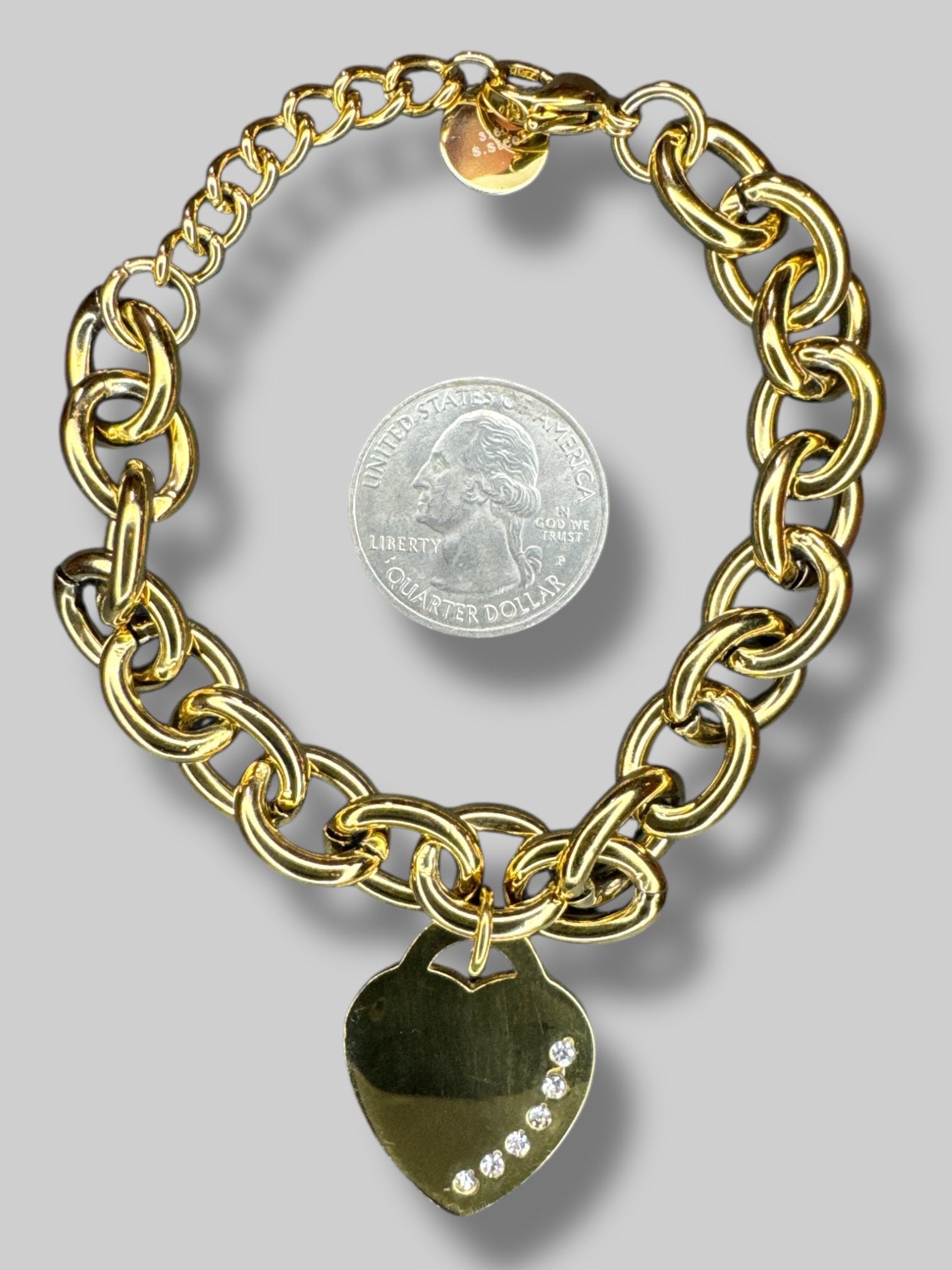 Gold metal chain bracelet with heart pendant with bedazzling