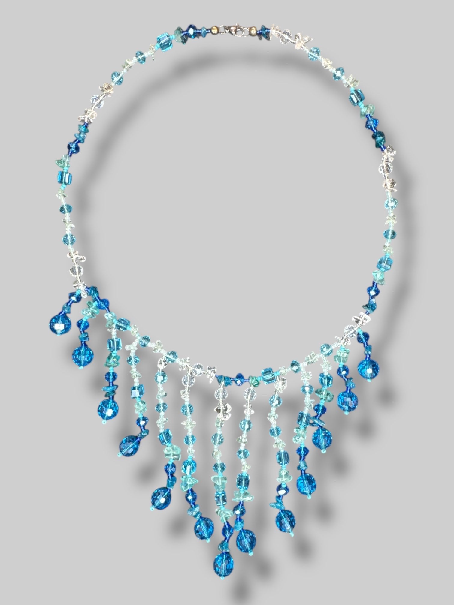 Blue and clear beaded necklace with layered tassels