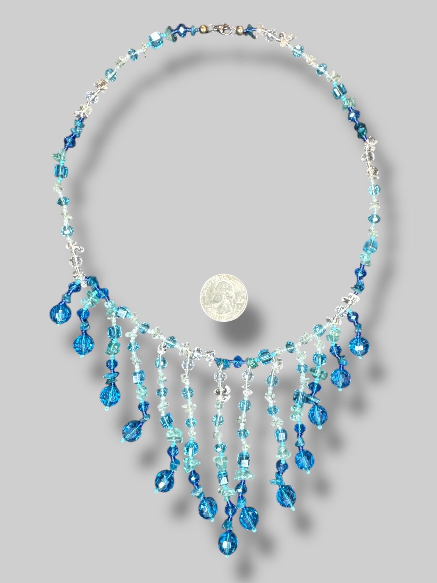Blue and clear beaded necklace with layered tassels