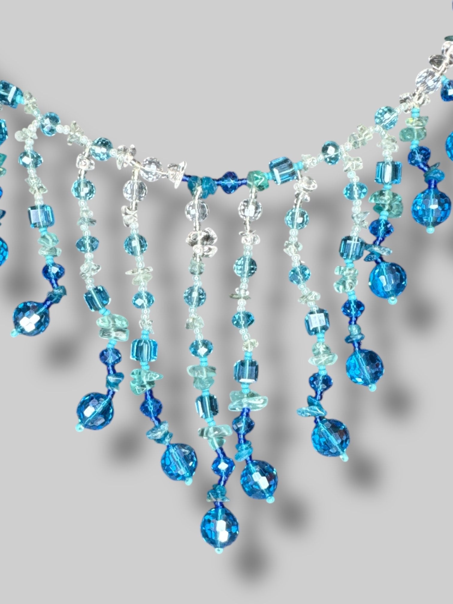 Blue and clear beaded necklace with layered tassels