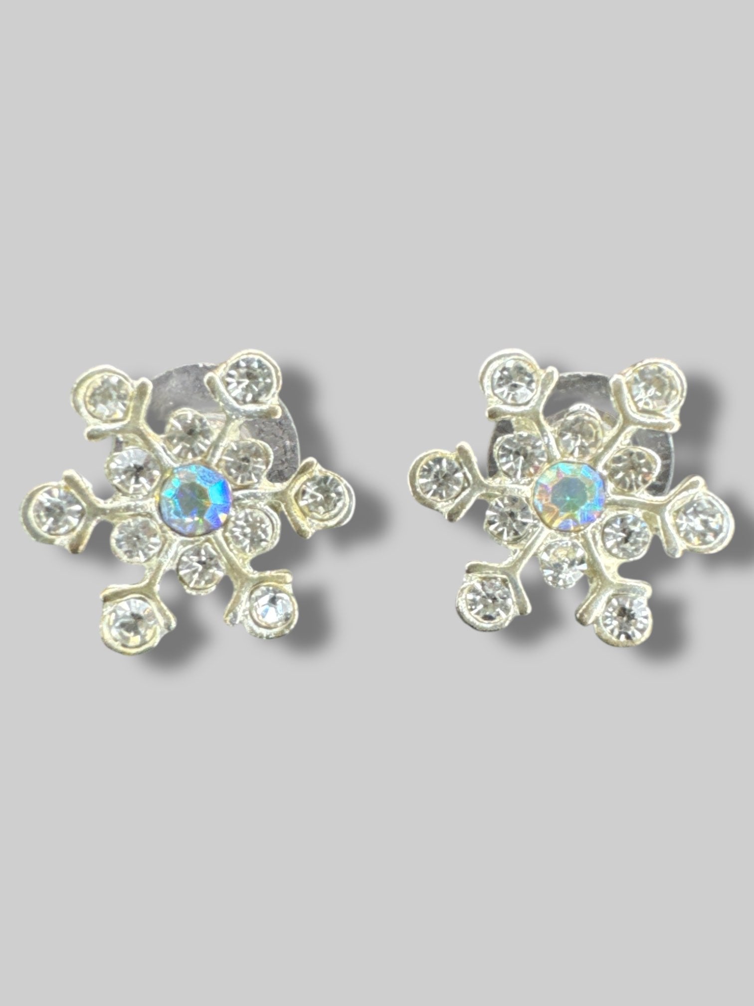 Bedazzled snowflake earrings with iridescent gem in middle