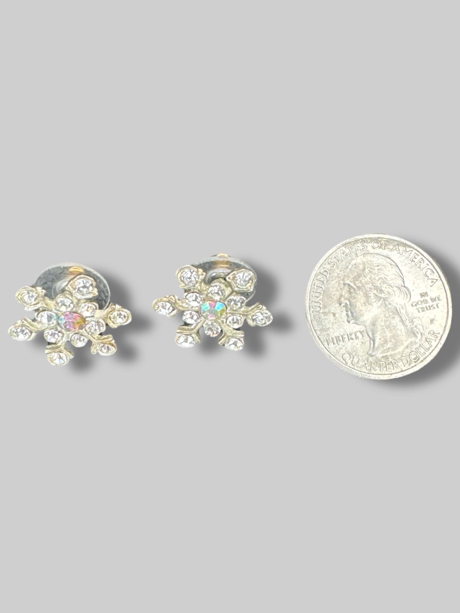 Bedazzled snowflake earrings with iridescent gem in middle