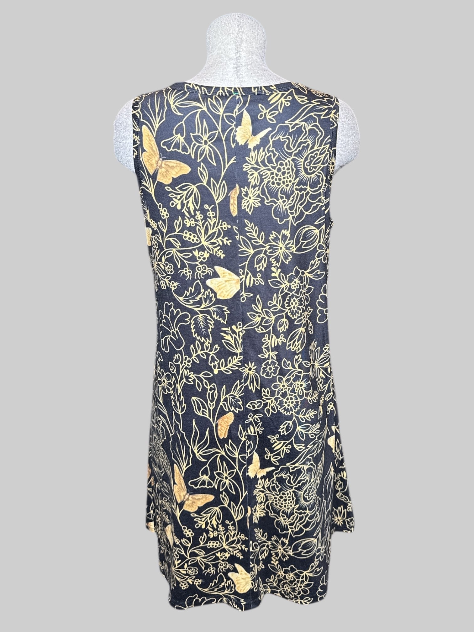 L black sleeveless dress with gold colored florals with butterflies, and pockets
