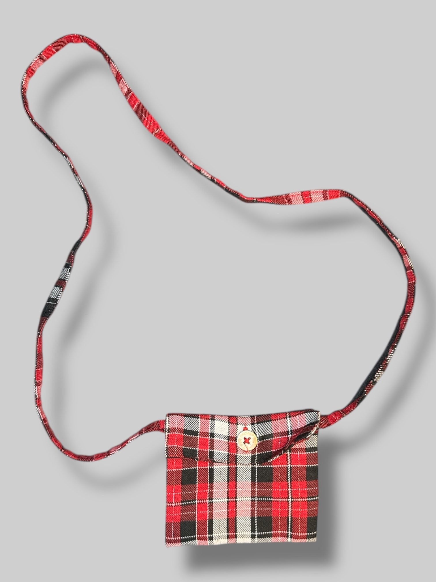 4.5’ little green, white, red, black, and metallic plaid purse with button