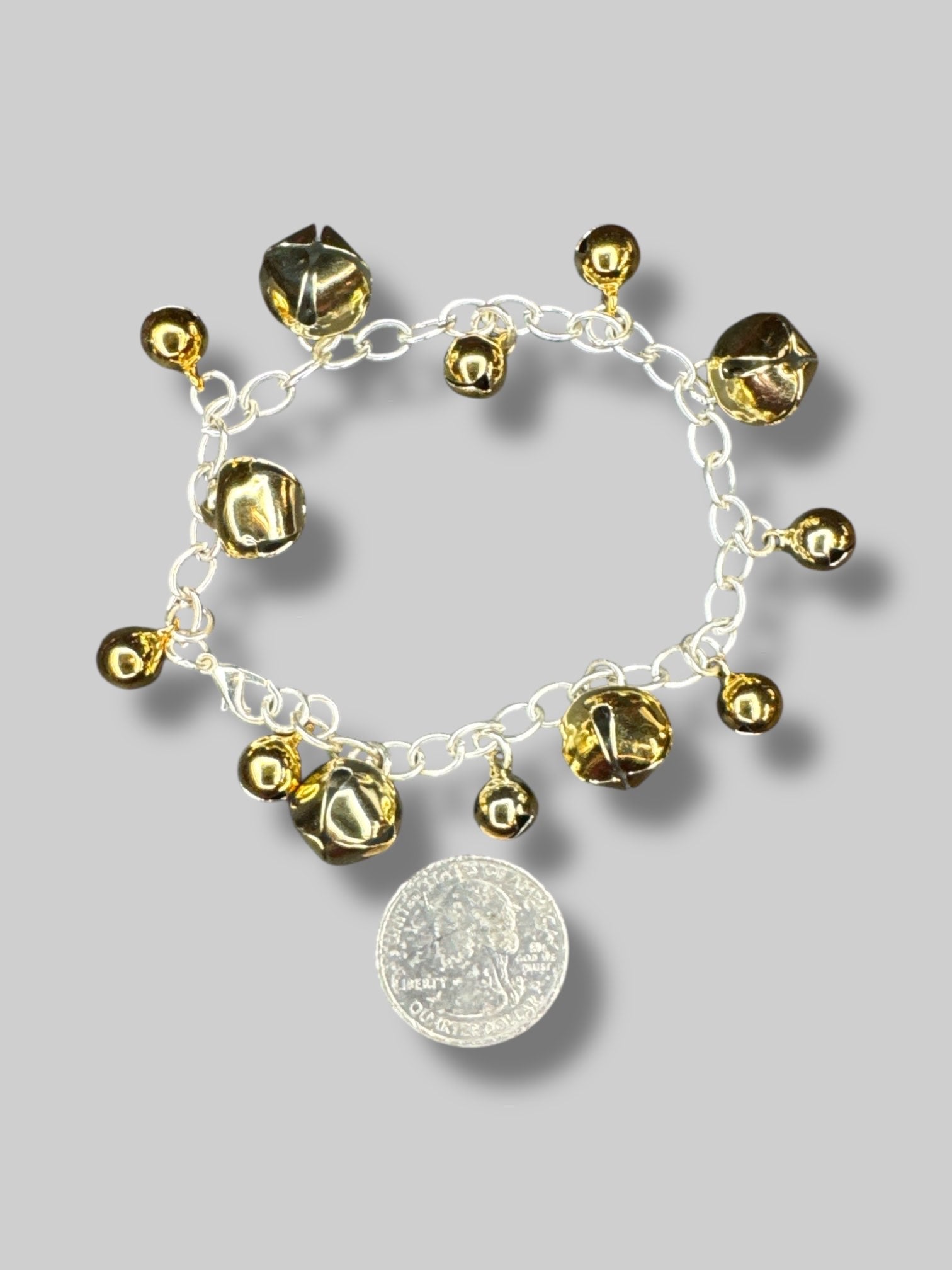 Silver tone bracelet with gold color bells