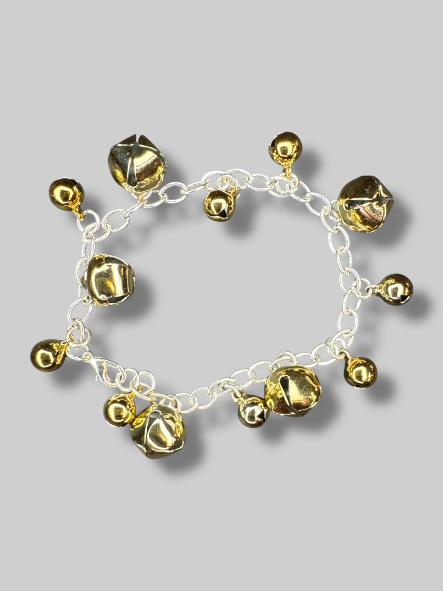Silver tone bracelet with gold color bells