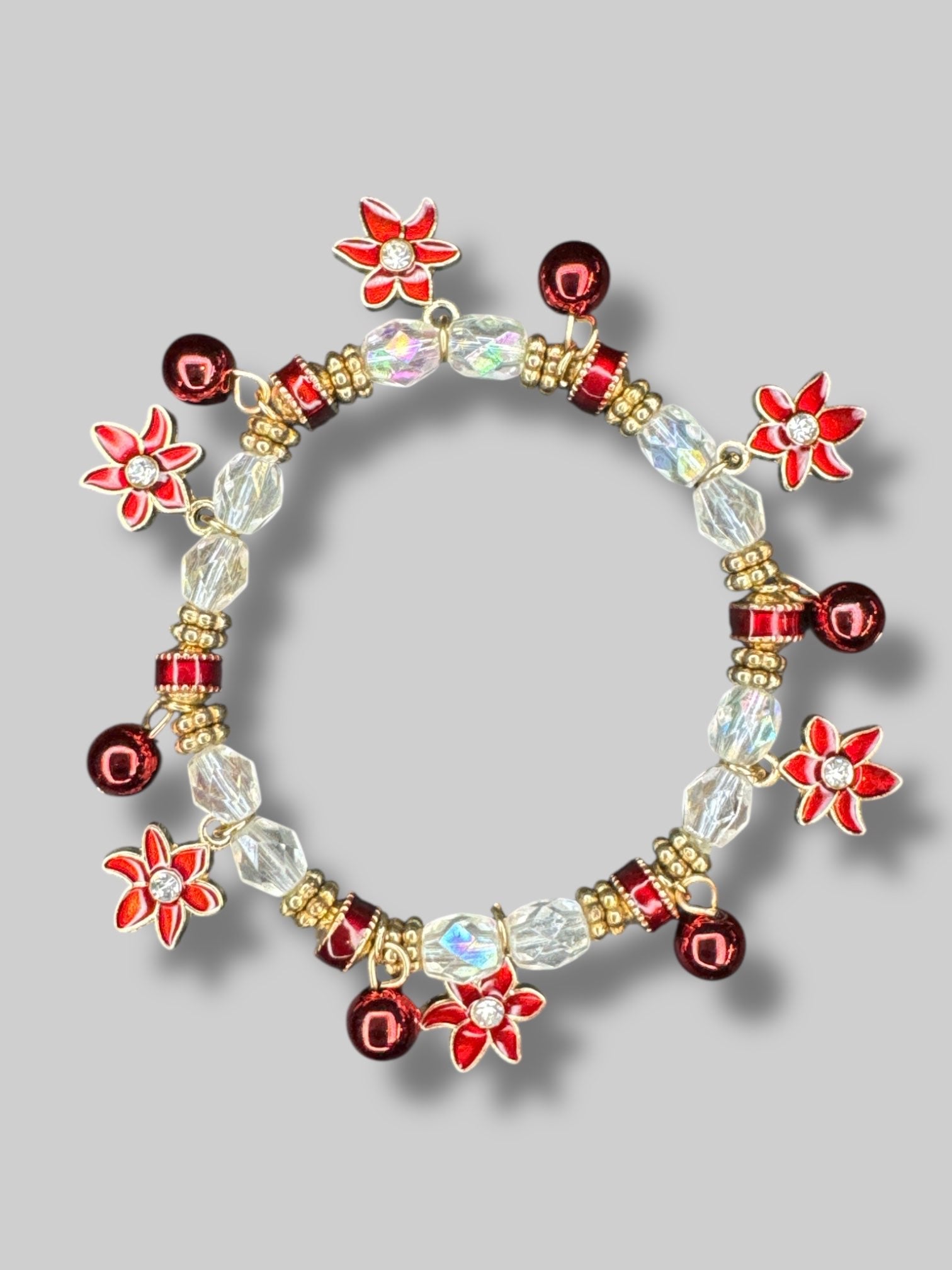 White, red, and gold color beaded bracelet with poinsettia charms