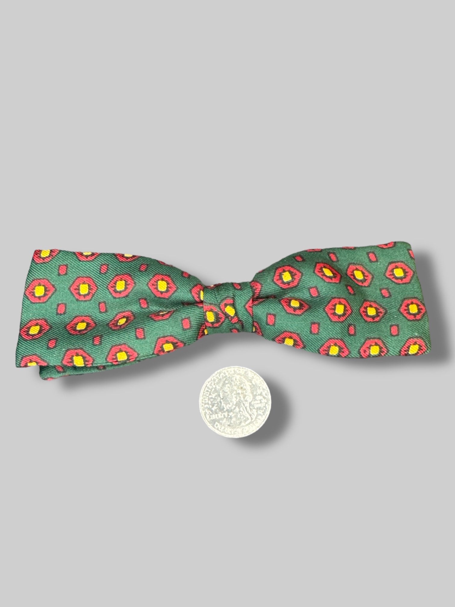 5’ green bow tie with red and yellow geometric pattern