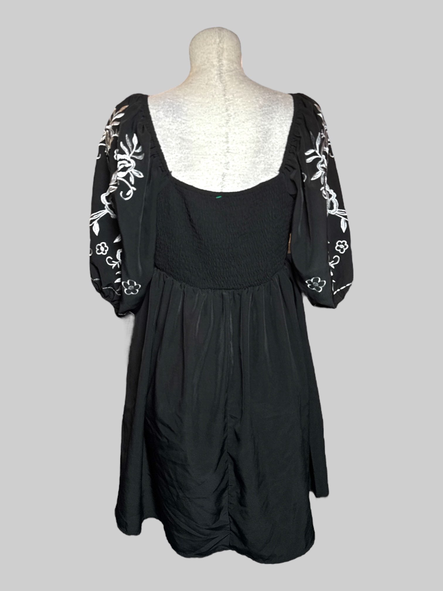 L black dress with white floral embroidery, balloon sleeves, and shirred back