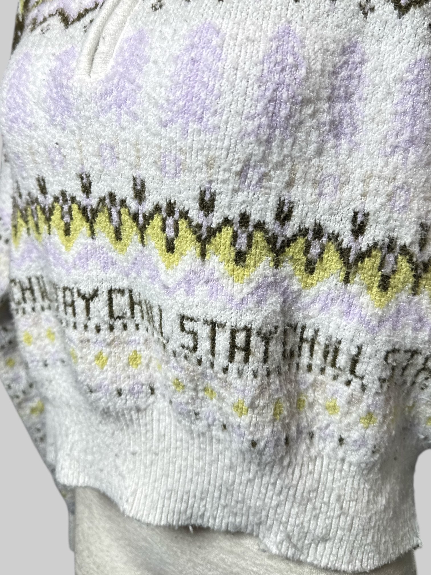 0X Arizona soft white  knit sweater with green, purple, and yellow geometric pattern, and “stay chill” lettering