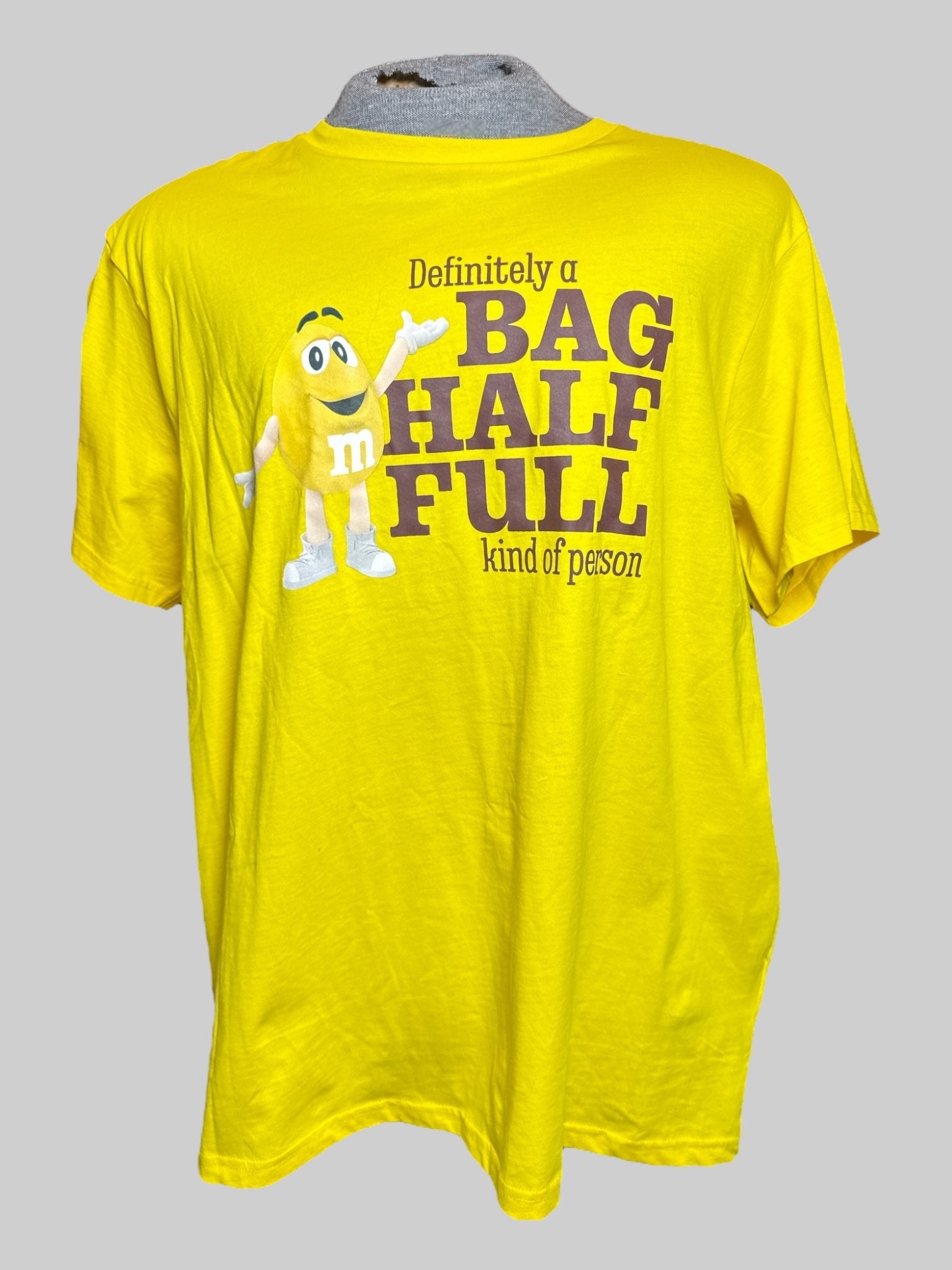 2X M&M’s yellow t shirt with lettering and graphic