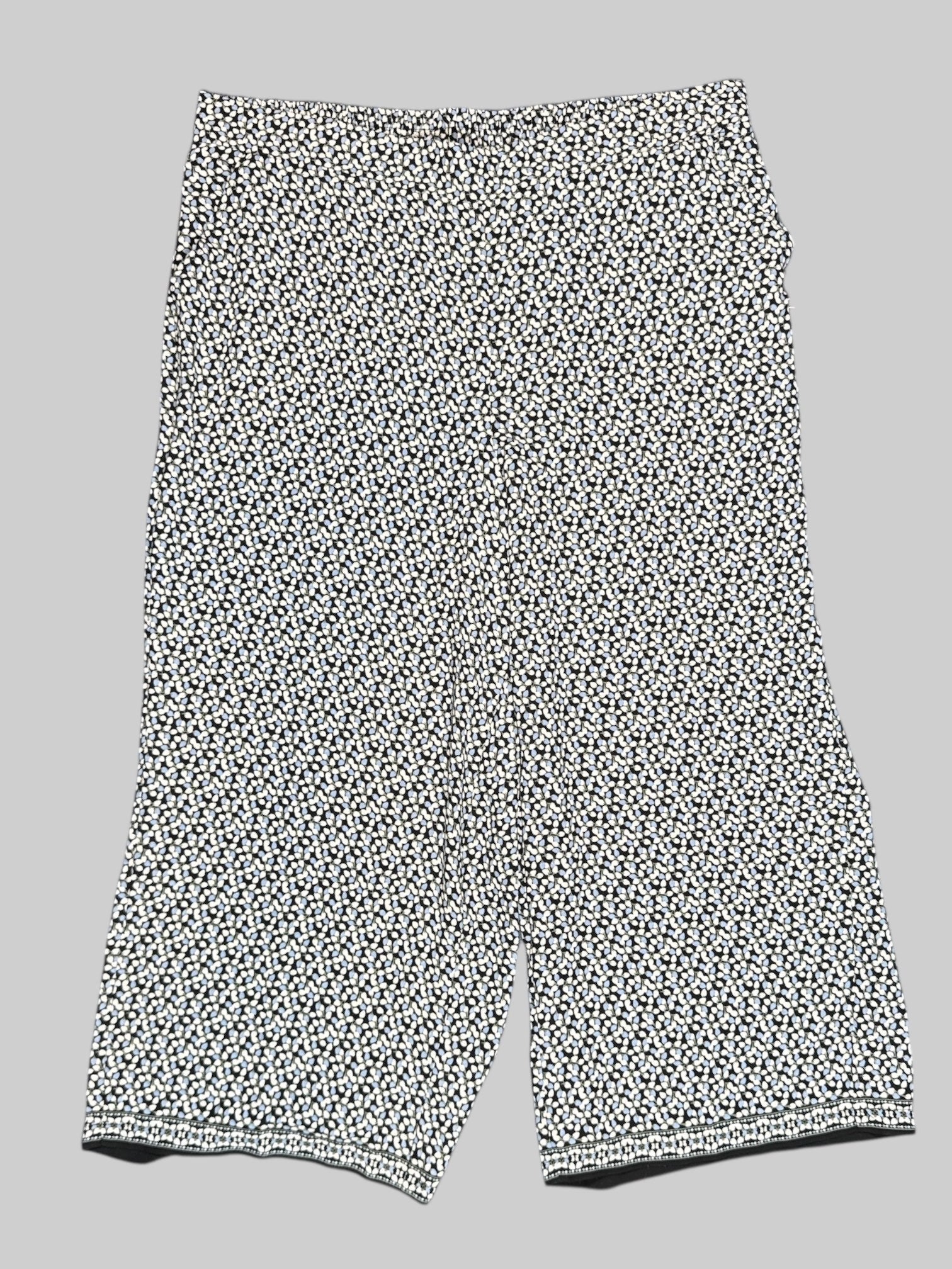 2X Max Studio black pants with white, blue, and green florals all over and elastic waistband