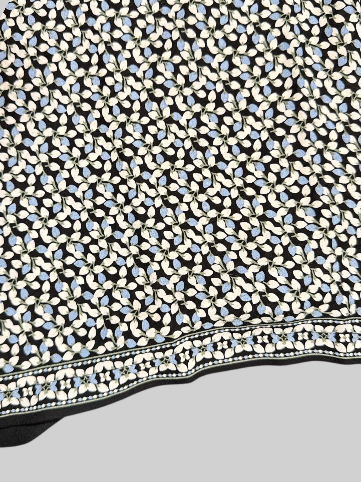 2X Max Studio black pants with white, blue, and green florals all over and elastic waistband