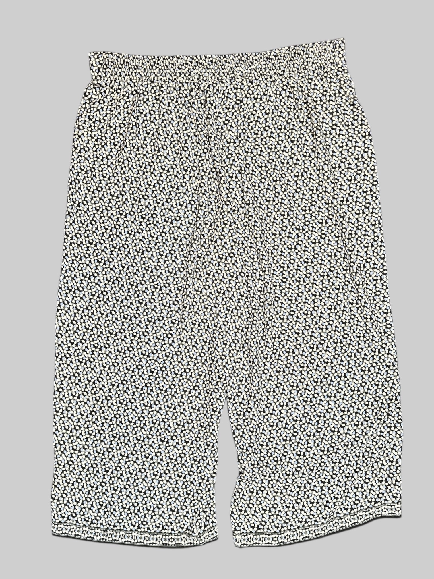 2X Max Studio black pants with white, blue, and green florals all over and elastic waistband