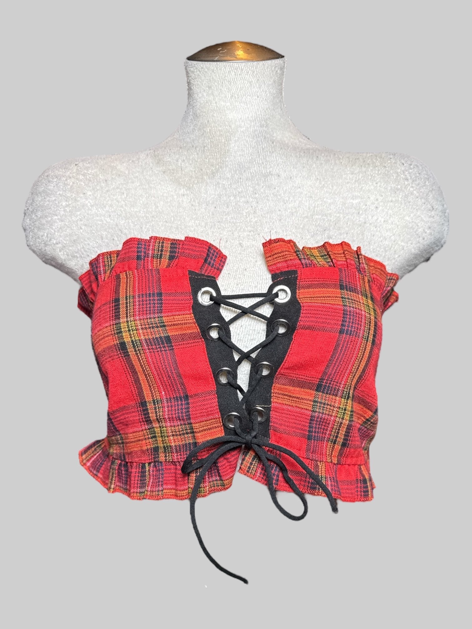 M red, yellow, white, and black plaid tube top with lace up front, ruffle trim, and shirred back
