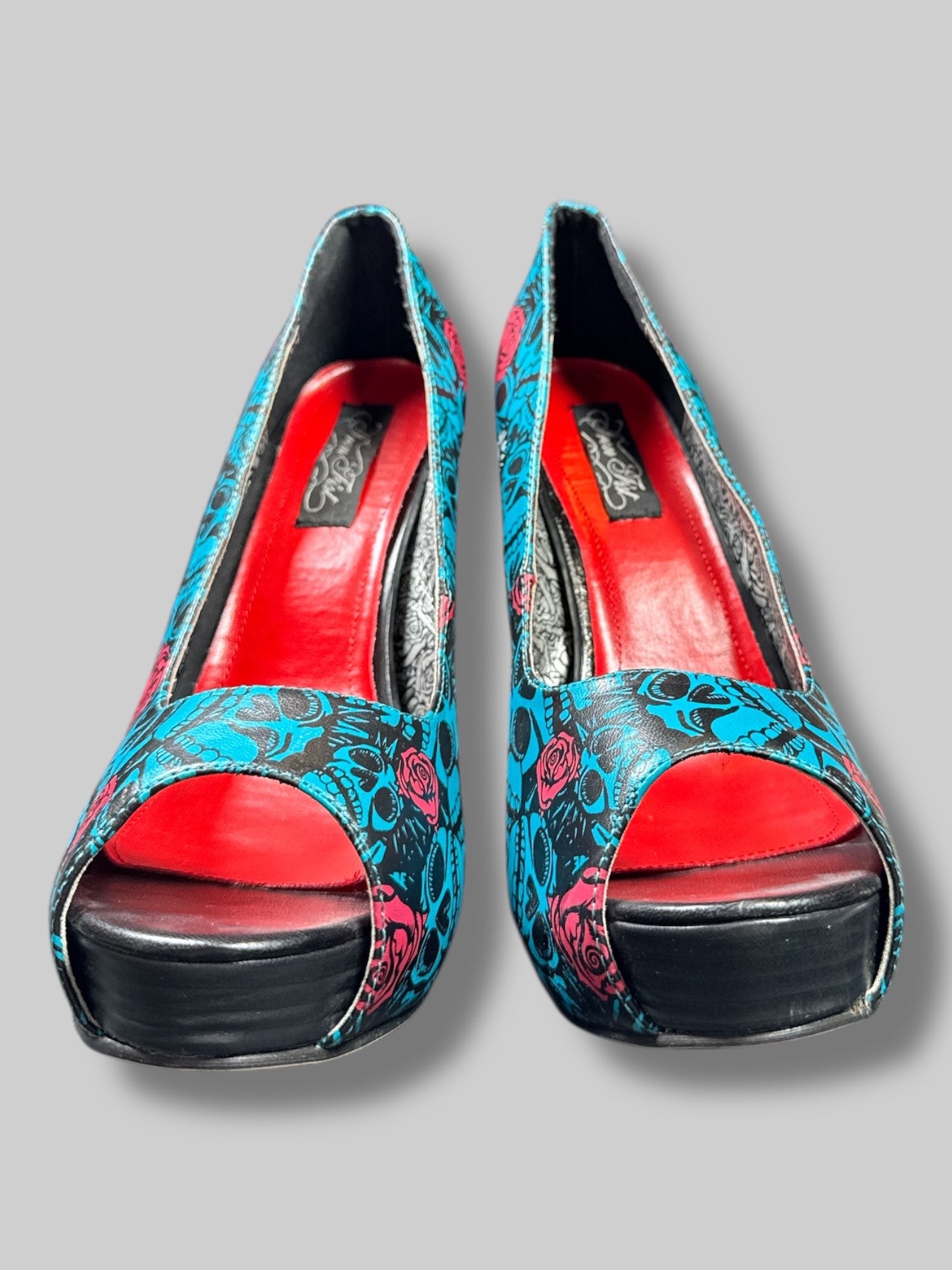 Size 42 Iron Fist blue and black skull pattern with roses and red and silver interior 5’ heels