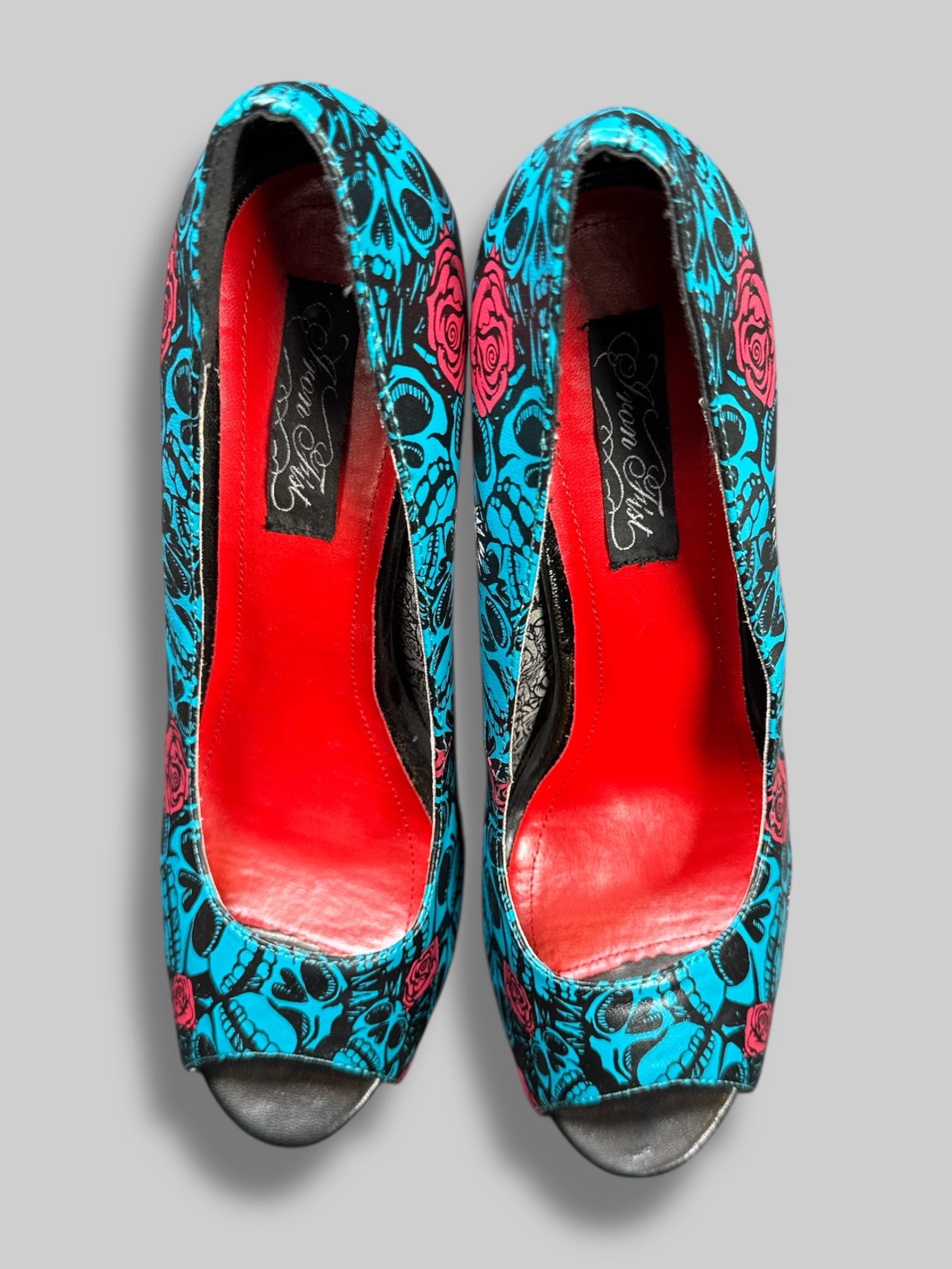 Size 42 Iron Fist blue and black skull pattern with roses and red and silver interior 5’ heels