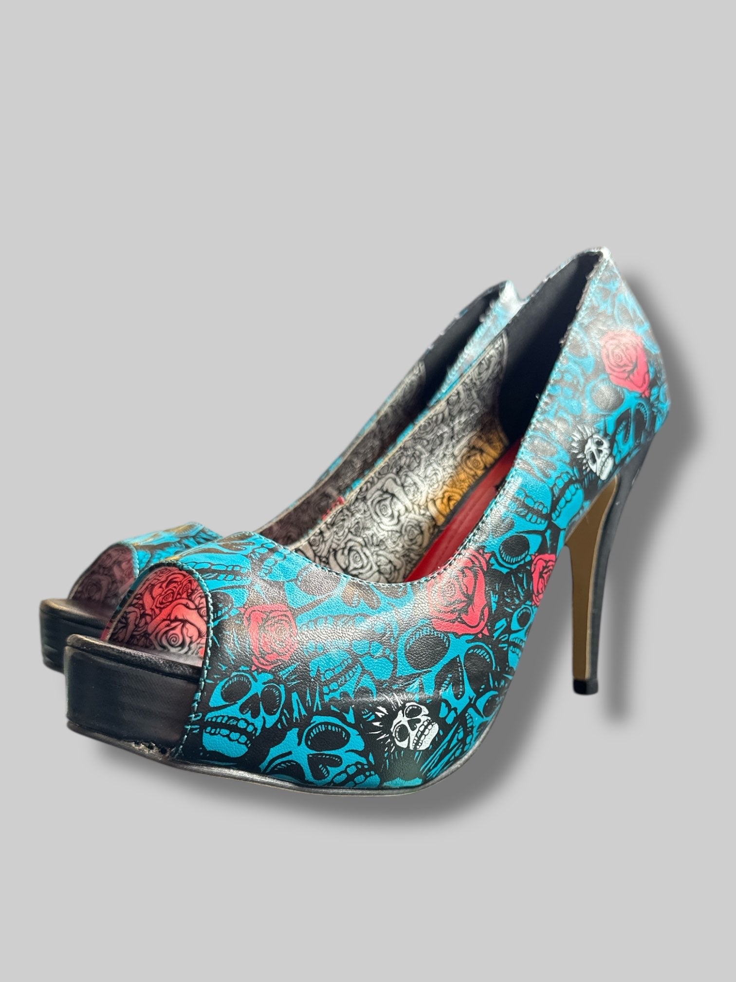 Size 42 Iron Fist blue and black skull pattern with roses and red and silver interior 5’ heels