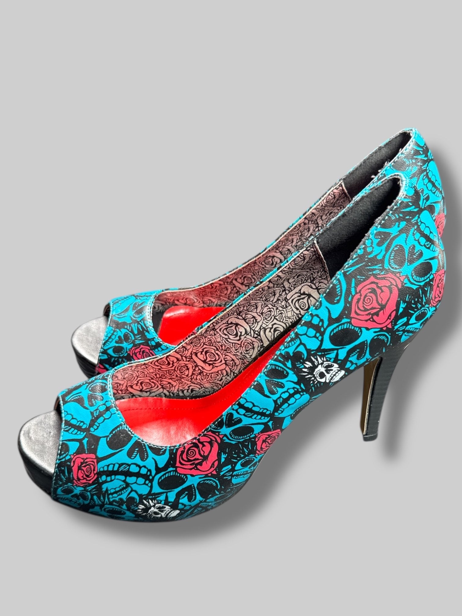 Size 42 Iron Fist blue and black skull pattern with roses and red and silver interior 5’ heels