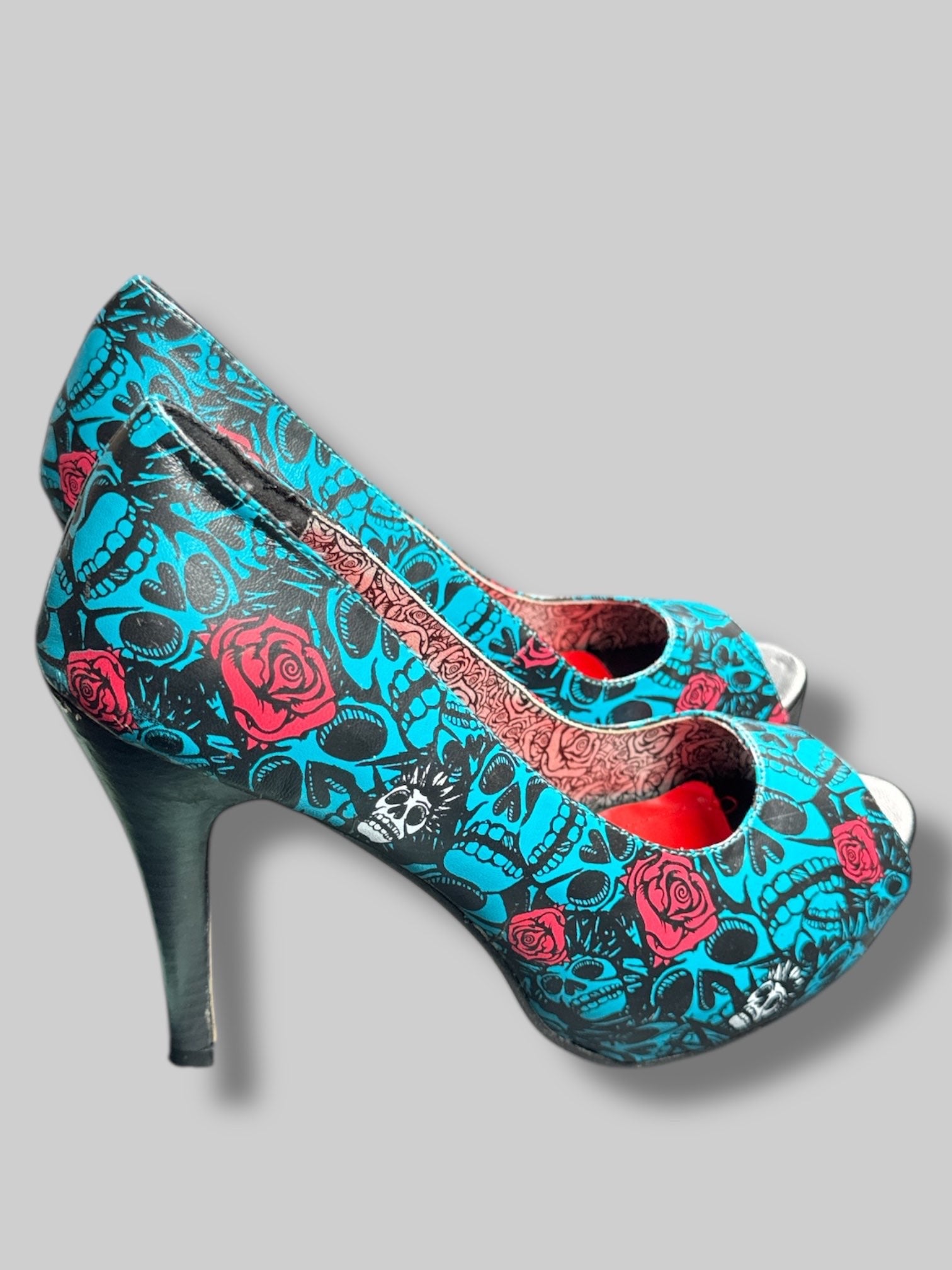 Size 42 Iron Fist blue and black skull pattern with roses and red and silver interior 5’ heels