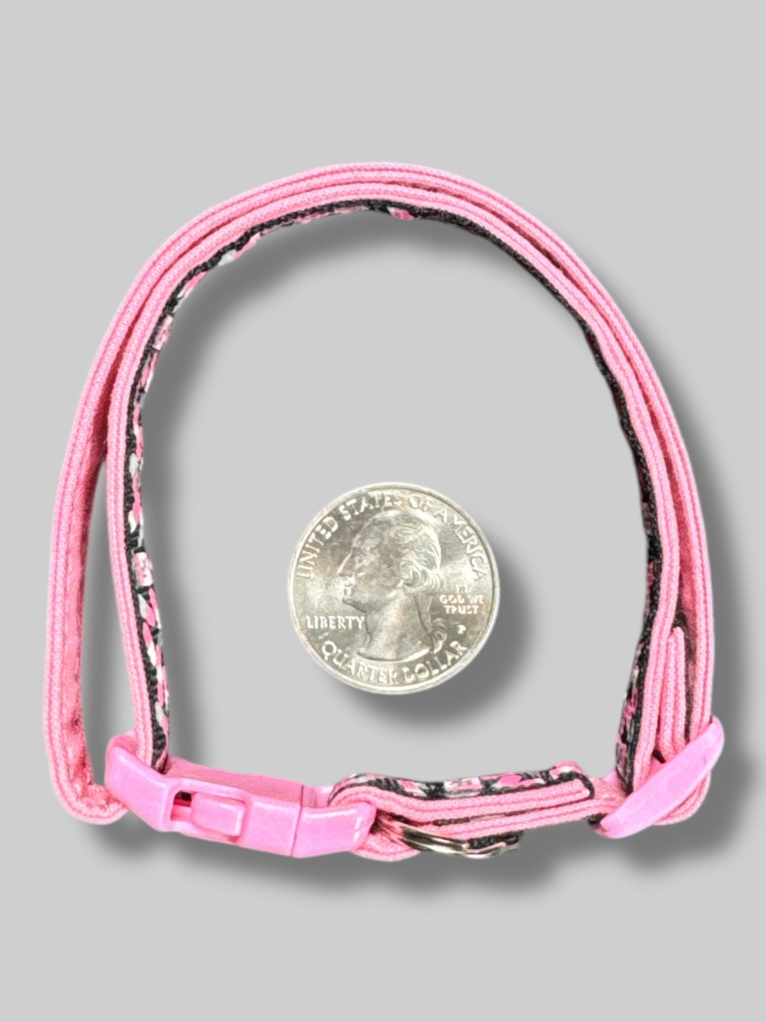 Pink, black, white, and gray cat collar with pill bottles and pills. 15’ long unclasped