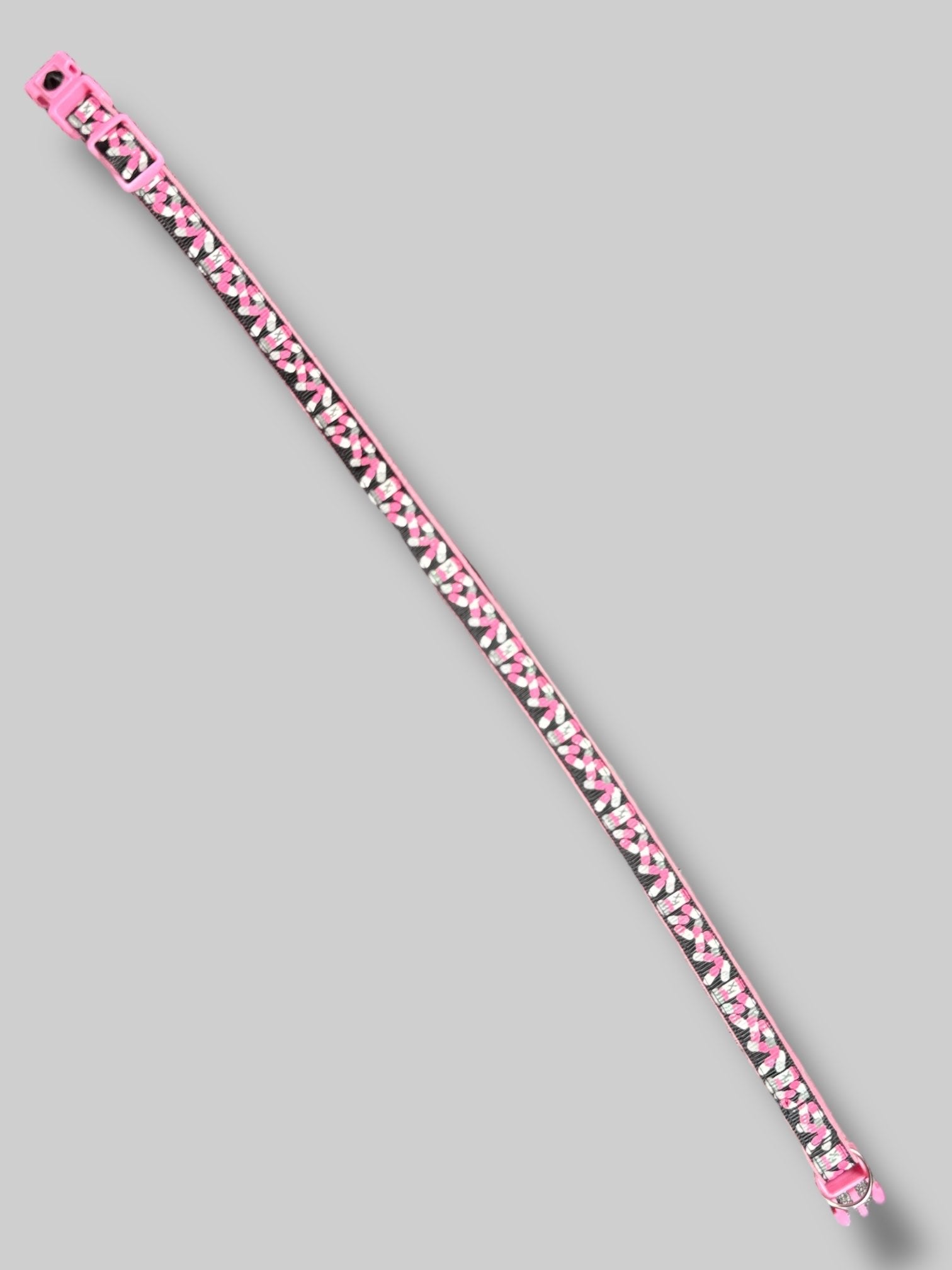 Pink, black, white, and gray cat collar with pill bottles and pills. 15’ long unclasped