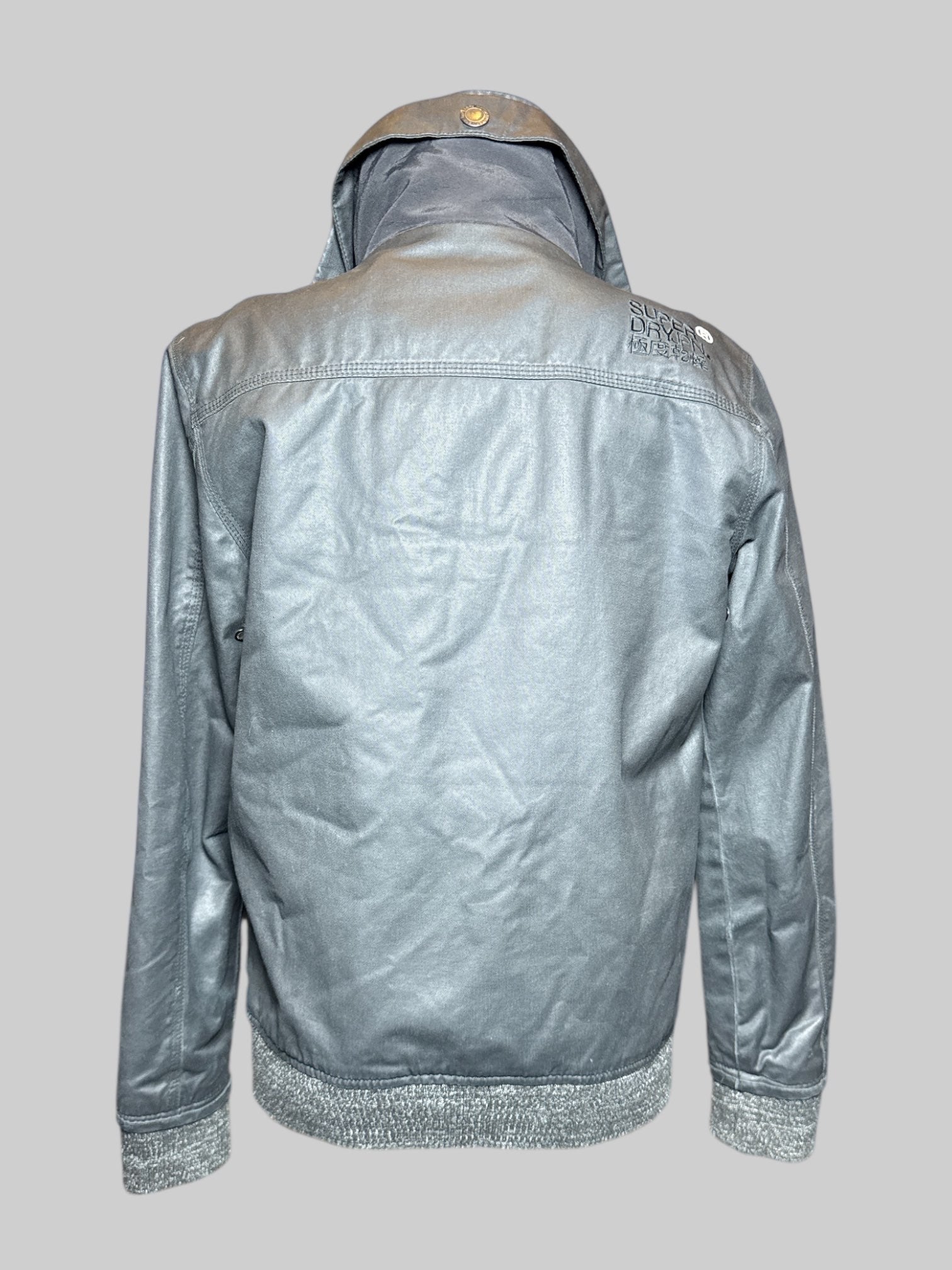 S Superdry black fleece lined zip up jacket with blue accents, zipper pockets, and multiple snap buttons