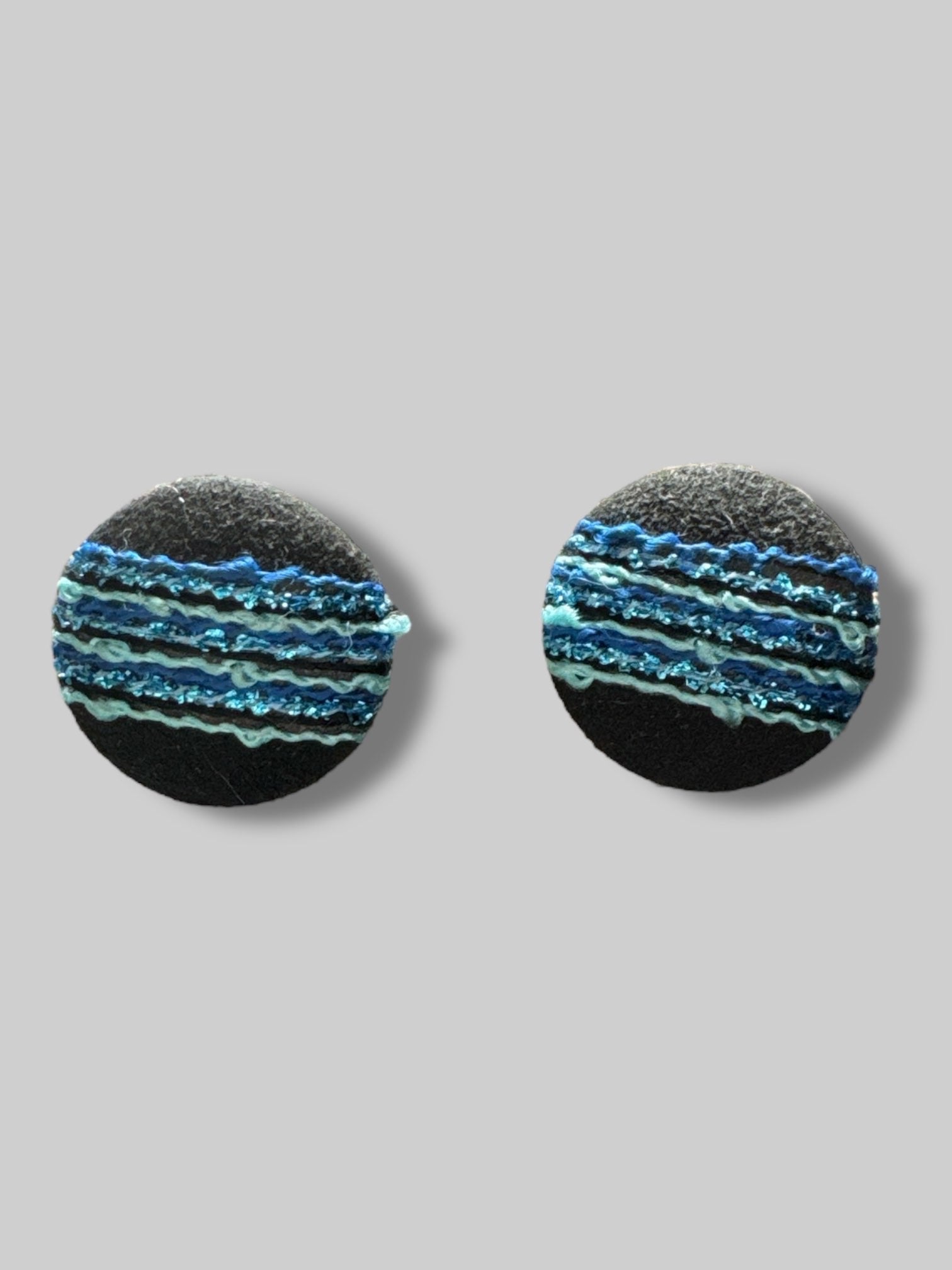 round black fabric with blue and metallic threads earrings