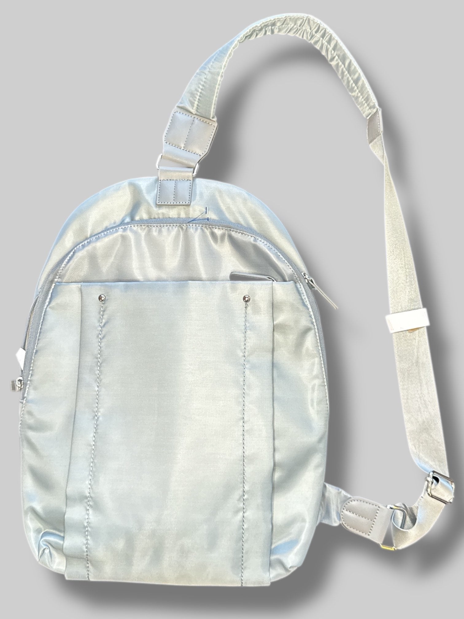 Francine Collections Silver lightly padded laptop backpack with one adjustable strap and many zipper pockets