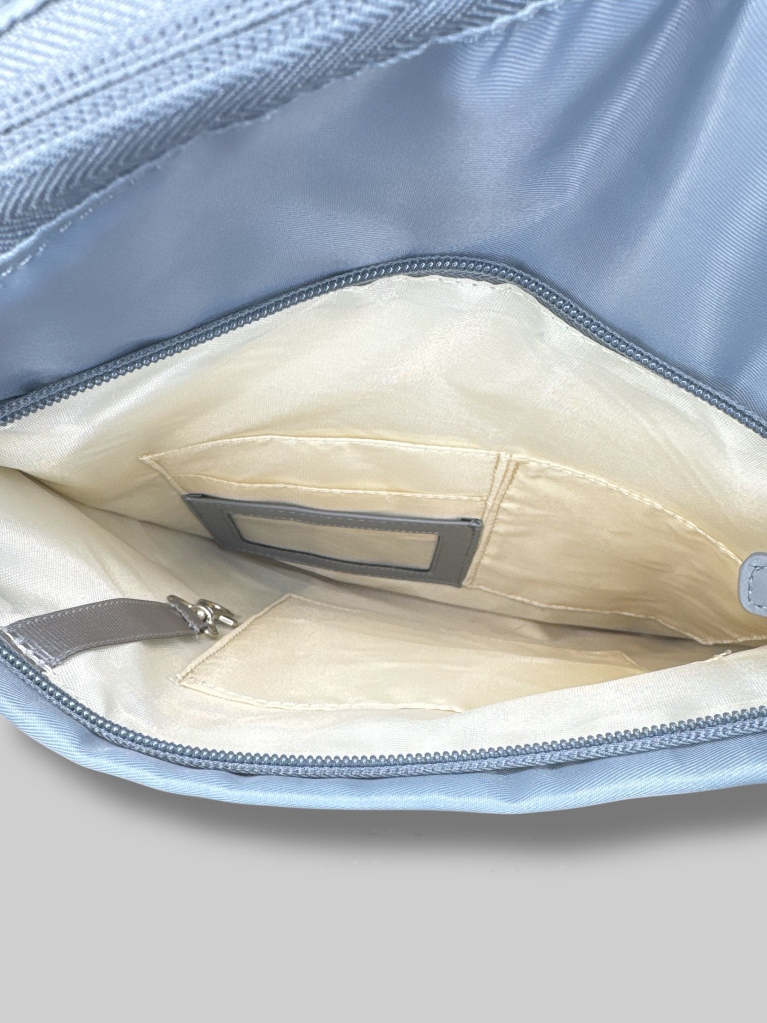 Francine Collections Silver lightly padded laptop backpack with one adjustable strap and many zipper pockets