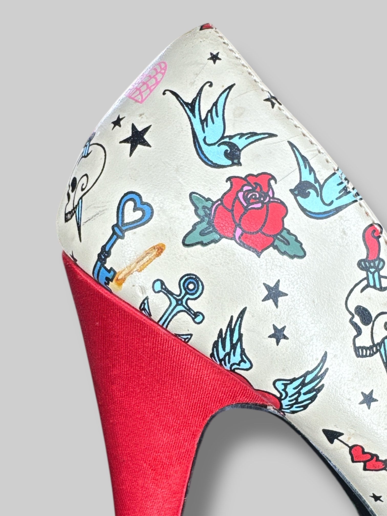 Size 6 Pin Up Couture tan stiletto heels with traditional tattoo designs, and bows on toes