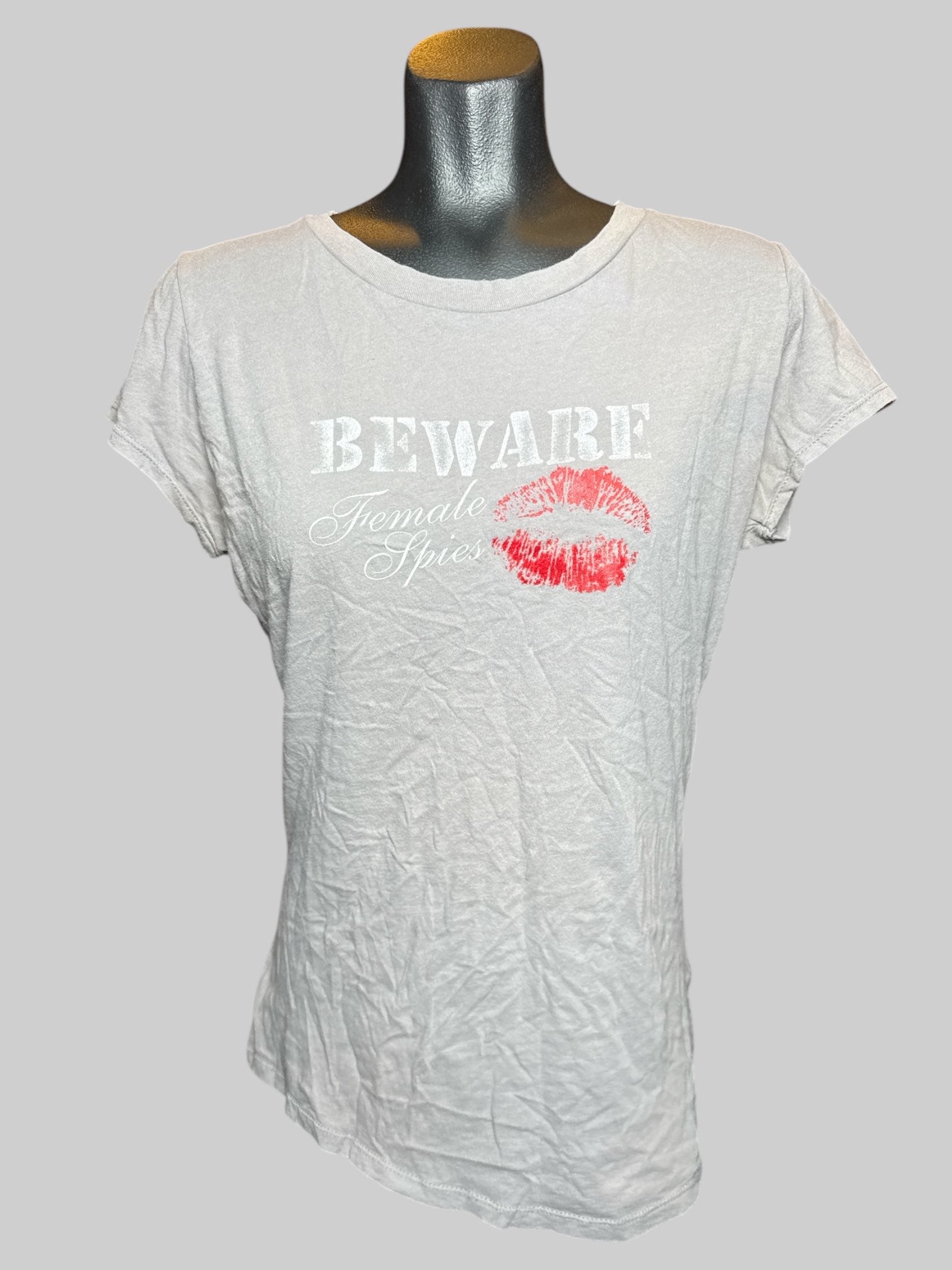 L International Spy Museum gray t shirt with “Beware female spies” graphic