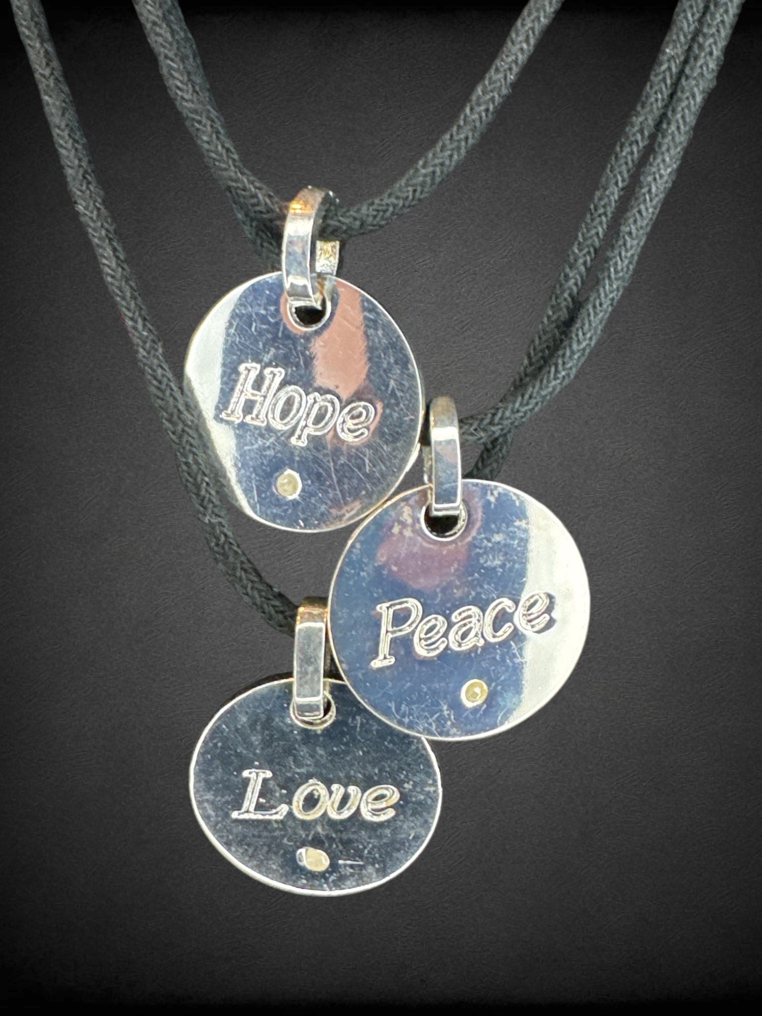 Set of 3 adjustable silver metal pendant necklaces with “Hope, Peace, Love” messages