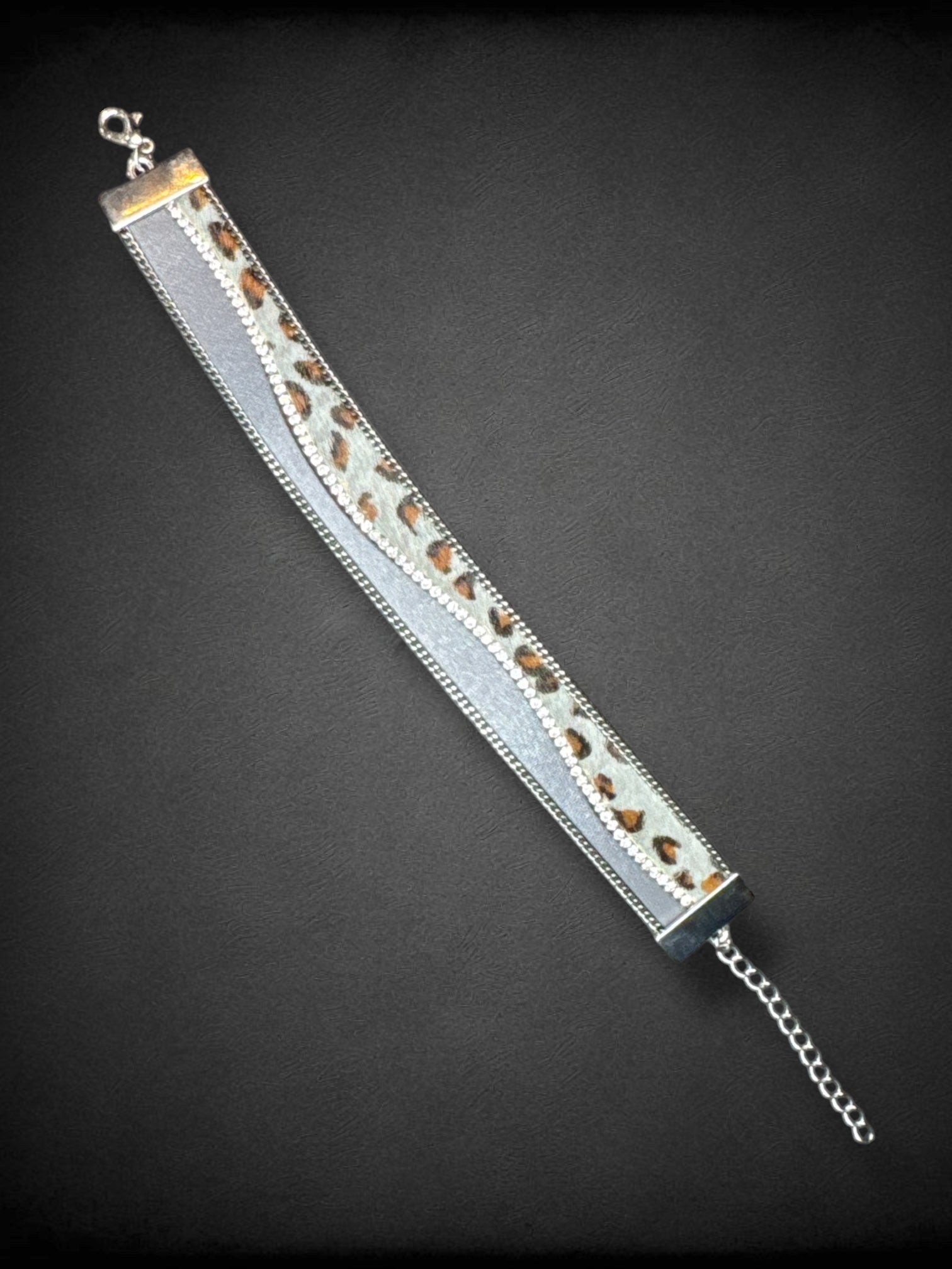 8” to 9.75” long Faux fur and leather bracelet with bedazzling and chain details