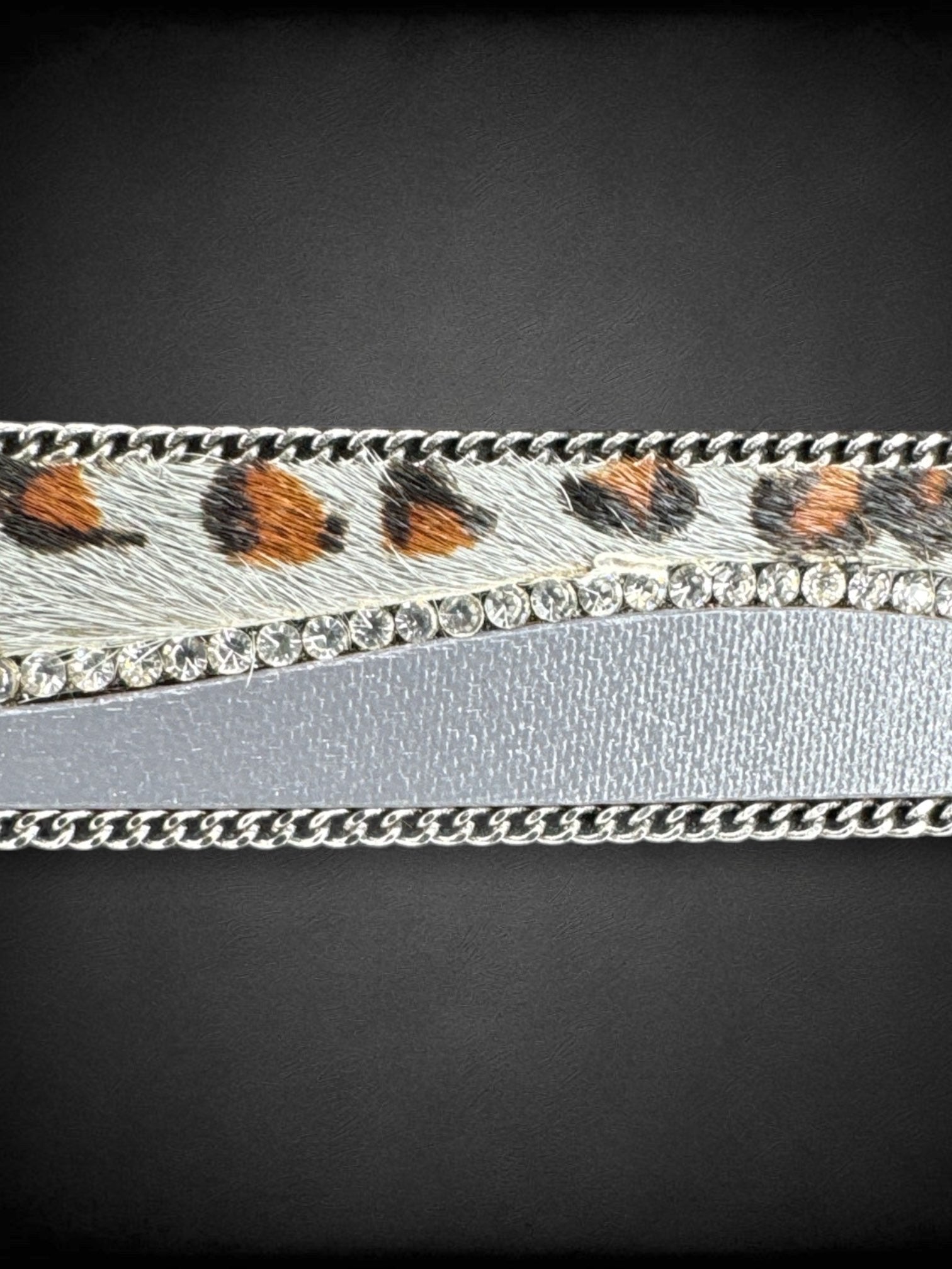 8” to 9.75” long Faux fur and leather bracelet with bedazzling and chain details