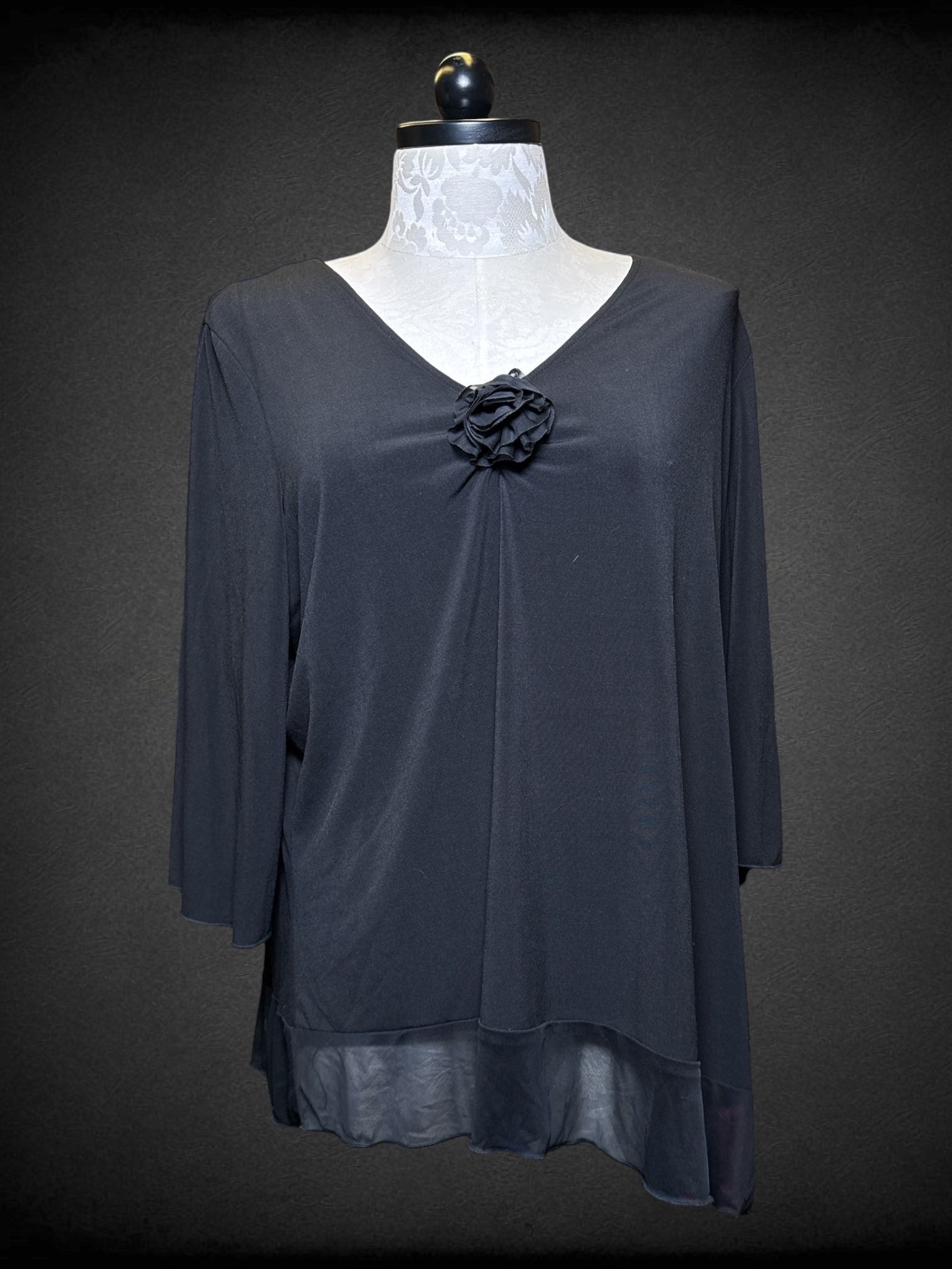 4X Fashion Bug black flowy blouse with 3D flower and sheer asymmetrical trim