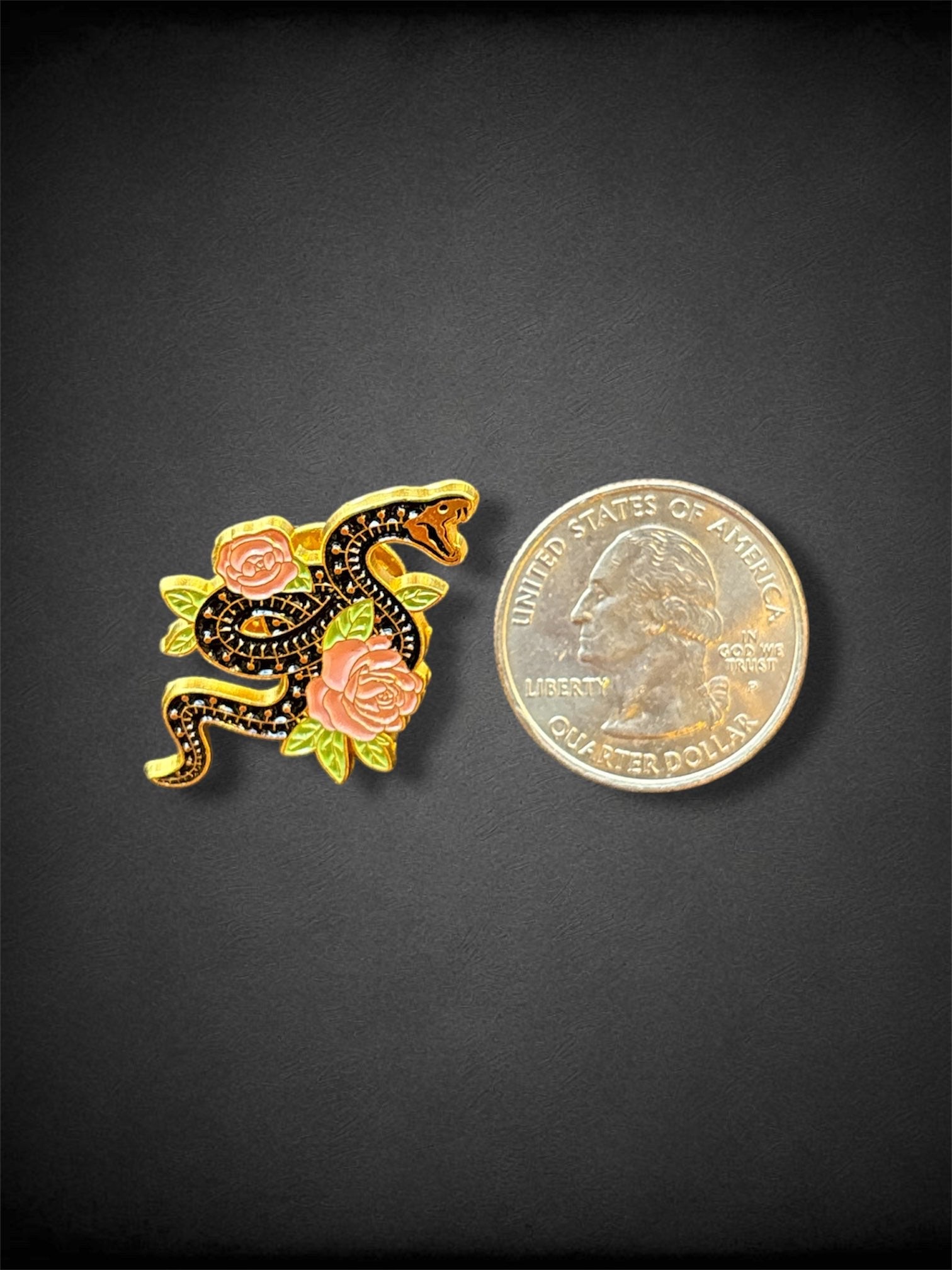 Black skeletal snake and flowers pin