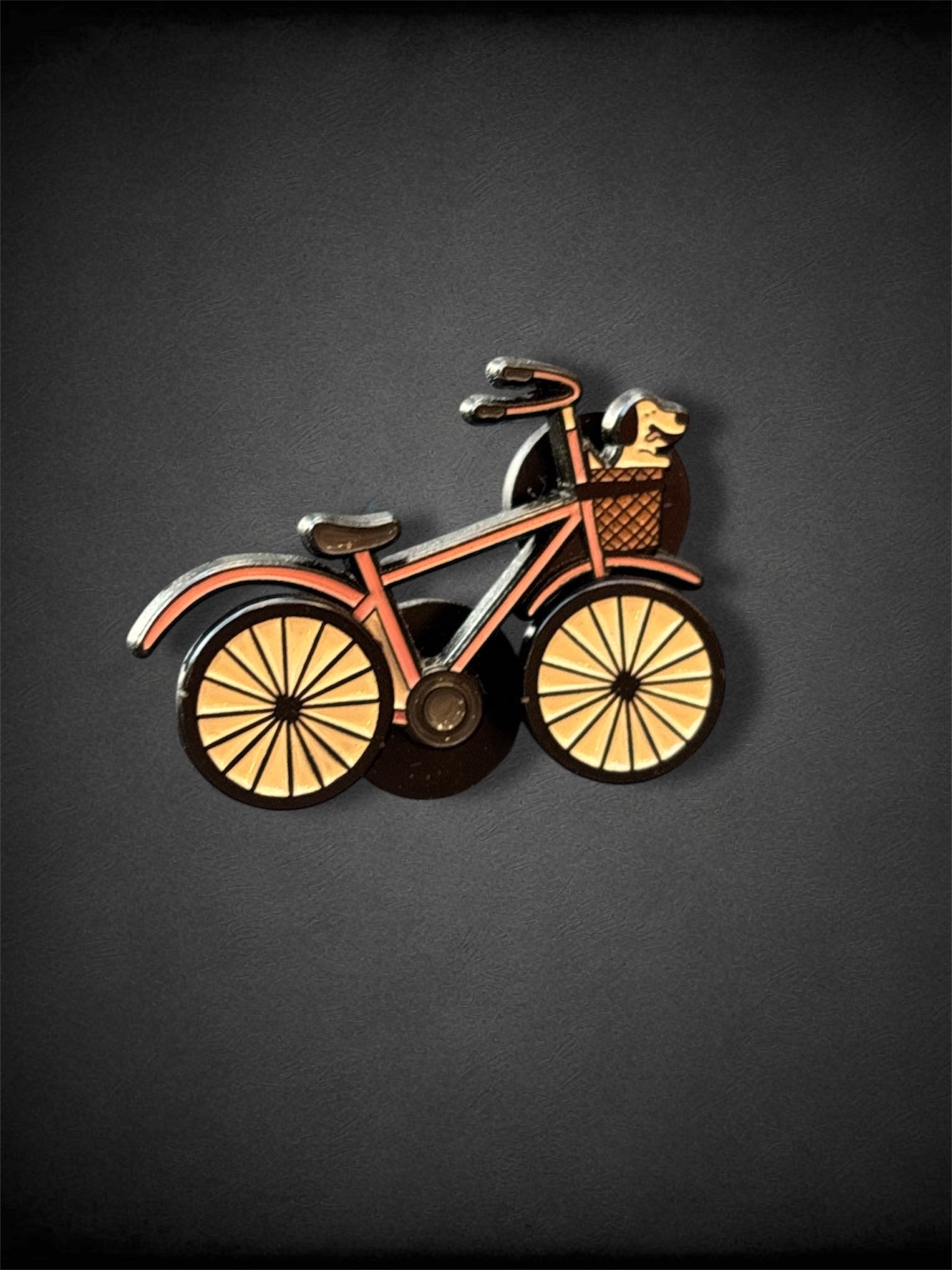 Pink bike with rotating wheels pin