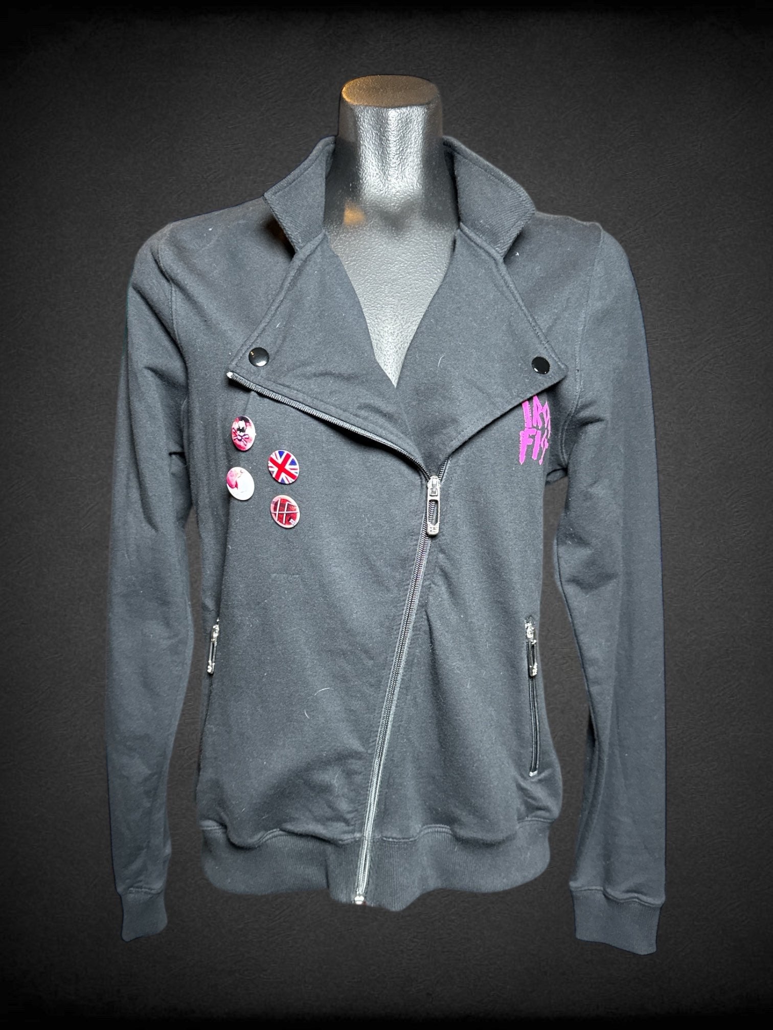 L Iron Fist black long sleeve zip up jacket with pink mohawk punk graphic, and British pins on front